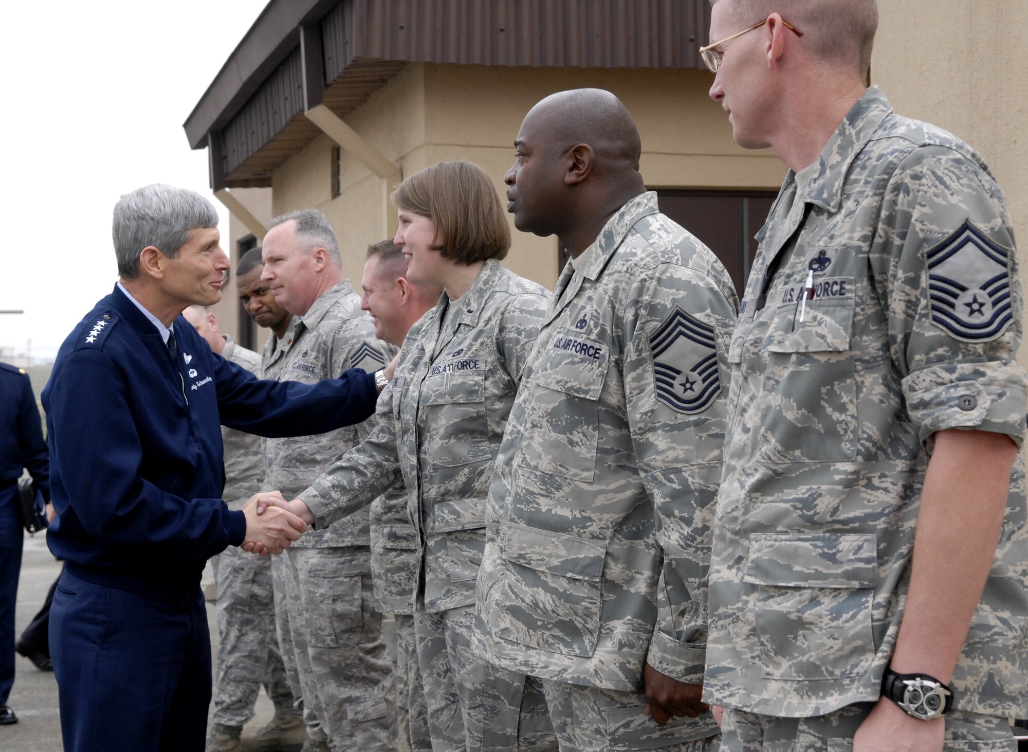 Air Force Chief of Staff Gen. Norton Schwartz greets Airmen outside the 25th Fighter Squadron building May 11 during his visit to Osan Air Base, South Korea. After his greeting, Gen. Schwartz received a tour of the 25th FS facility. He was there as part of his Pacific Air Force tour, visiting and talking to the Airmen.  (U.S. Air Force photo/Senior Airman Stephenie Wade) 
