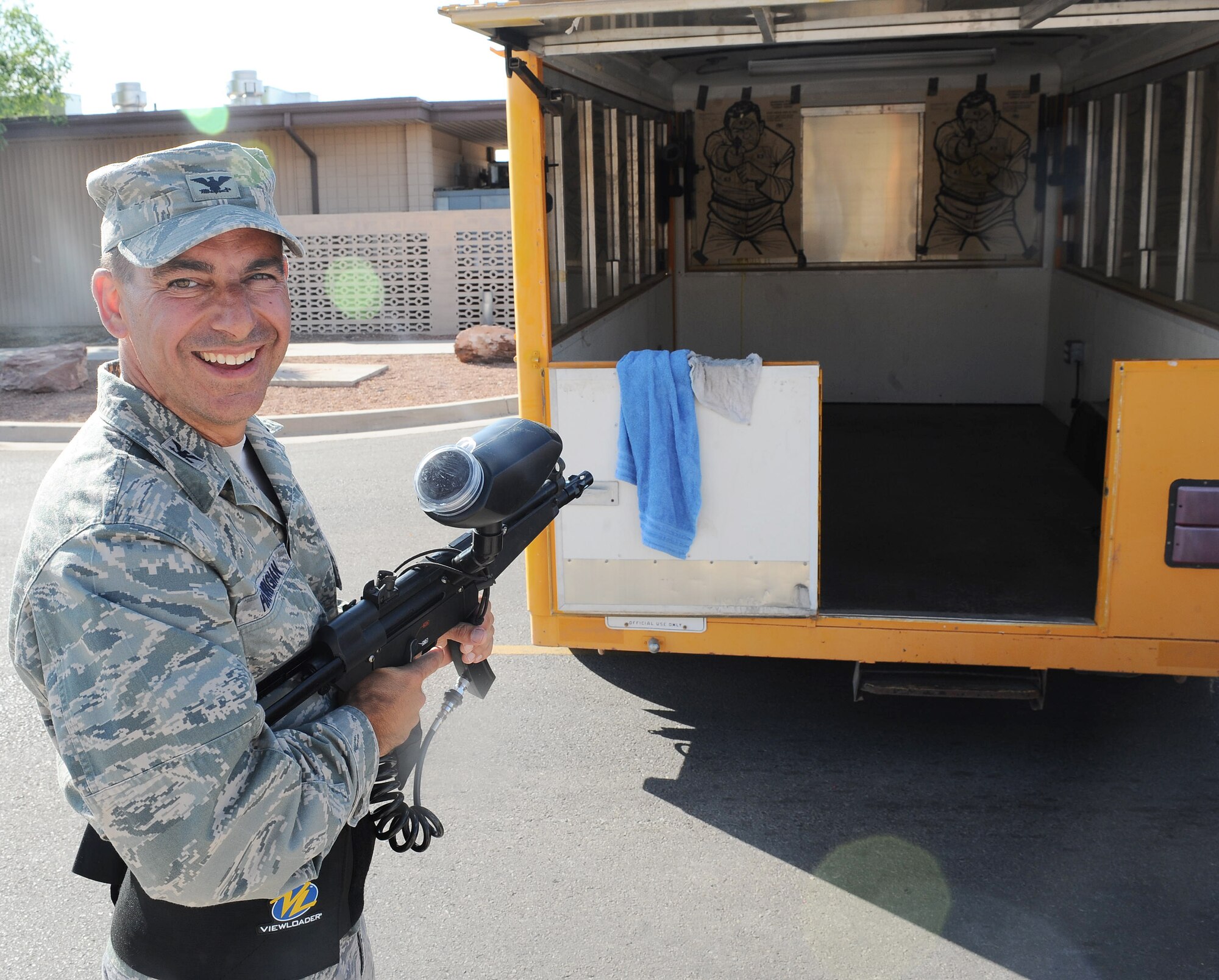 Col. Jeff Harrigian, 49th Fighter Wing commander, takes the first shots at the paintball booth as part of Summer Block Party at Holloman Air Force Base, N.M., May 15. Colonel Harrigian was given a tour of the new additions to Holloman which were built to benefit all such as the batting cages and the new pool.  (U.S. Air Force photo/ Airman 1st Class DeAndre Curtiss)