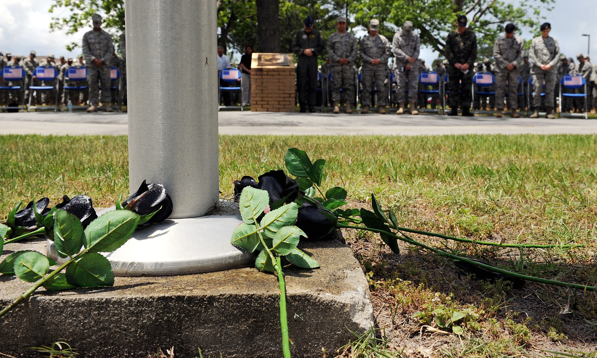MOODY AIR FORCE BASE, Ga. -- Black roses lay at the base of a flag pole during a National Police Week ceremony here May.15. The roses represent fallen police officers from both the Air Force and civilian community. (U.S. Air Force photo by Airman 1st Joshua Green) 