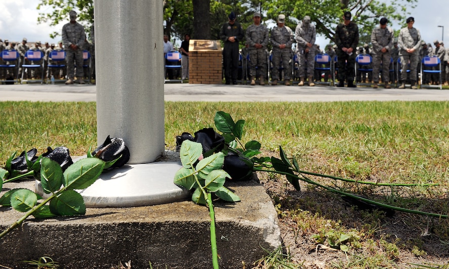 MOODY AIR FORCE BASE, Ga. -- Black roses lay at the base of a flag pole during a National Police Week ceremony here May.15. The roses represent fallen police officers from both the Air Force and civilian community. (U.S. Air Force photo by Airman 1st Joshua Green) 