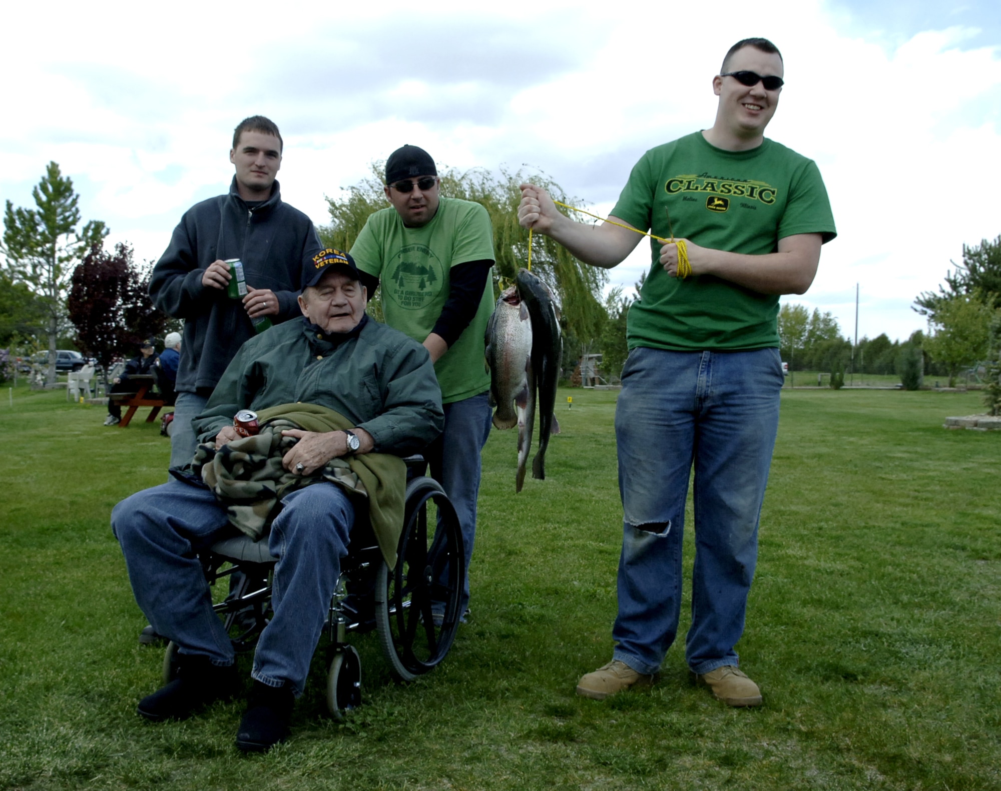 CALDWELL, Idaho - Staff Sgt. Chris St Peter, and Senior Airmen Jeremy Grey and Derek White, 366th Equipment Maintenance Squadron, show off Korean War veteran Richard Nelson’s catches during the Idaho State Veterans Home Fishing Buddy Program May 12 in Caldwell, Idaho. Mr. Nelson was one of about 30 veterans who came out to fish with Airmen from Mountain Home AFB and Gowen Field, Boise, Idaho. (U.S. Air Force photo\Staff Sgt. Jasmine Reif)
