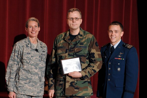 Lt. Col. Leemon Baird, center, receives a 2009 Heiser Award from Brig. Gen. Dana Born, dean of the faculty, and Cadet 1st Class Jacob Schonig, Fall 2008 cadet wing commander, during an award presentation May 7. Each graduating class selects two senior faculty members from more than 160 eligible professors to receive the award. (U.S. Air Force photo/Dennis Rogers)