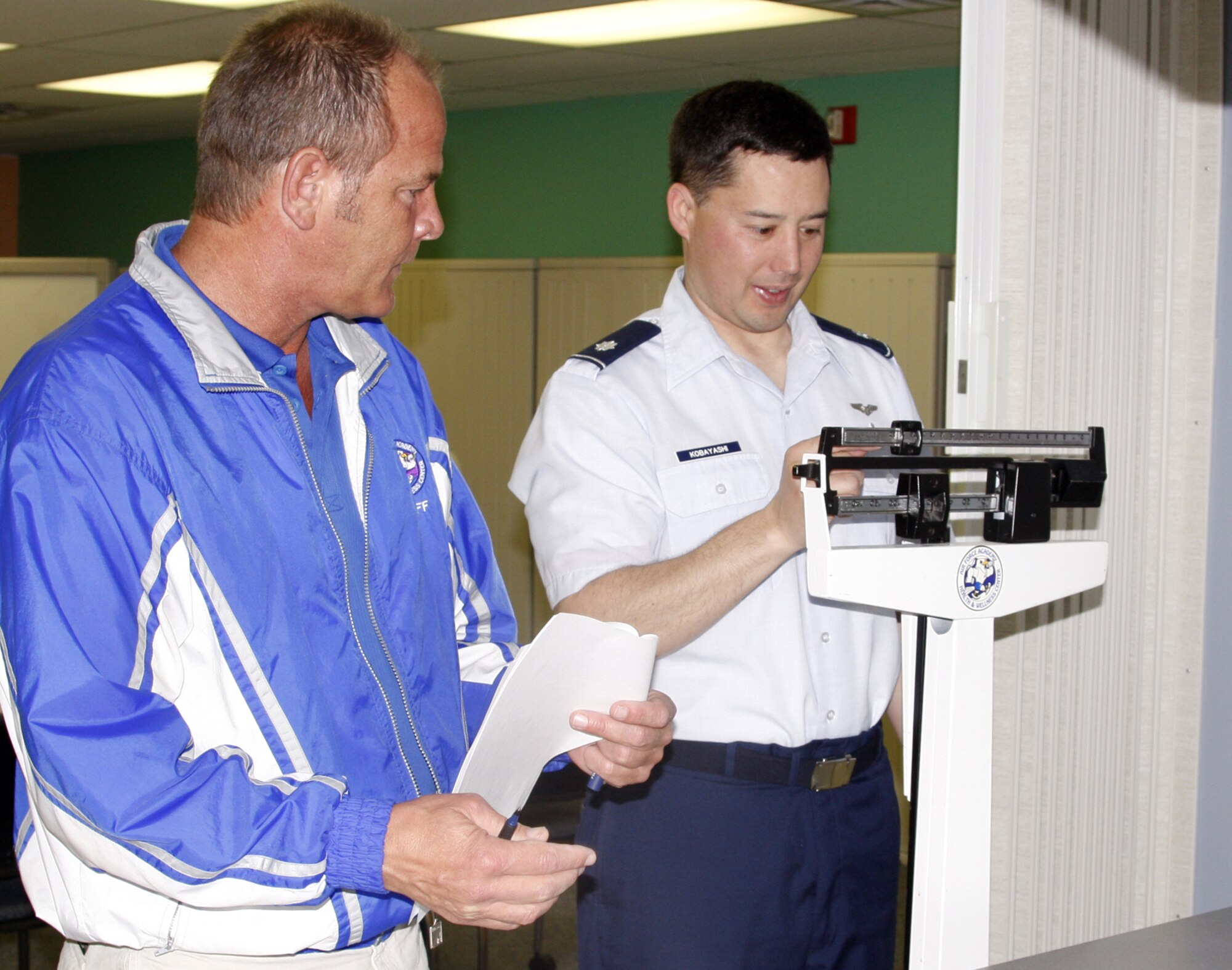Lt. Col. (Dr.) Todd Kobayashi weighs in Tuesday at the U.S. Air Force Academy's Health and Wellness Center as the conclusion of a 12-week program called "Fitness Challenge" approaches. The HAWC staff put approximately 230 participants on course toward healthier lifestyles through increased focus on diet and exercise. (U.S. Air Force photo/Ken Carter)