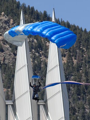A cadet with the Wings of Blue parachute team provides an aerial demonstration landing on the Terrazzo before the cadet wing in conjunction with the noon meal formation May 6. (U.S. Air Force photo/Dennis Rogers)