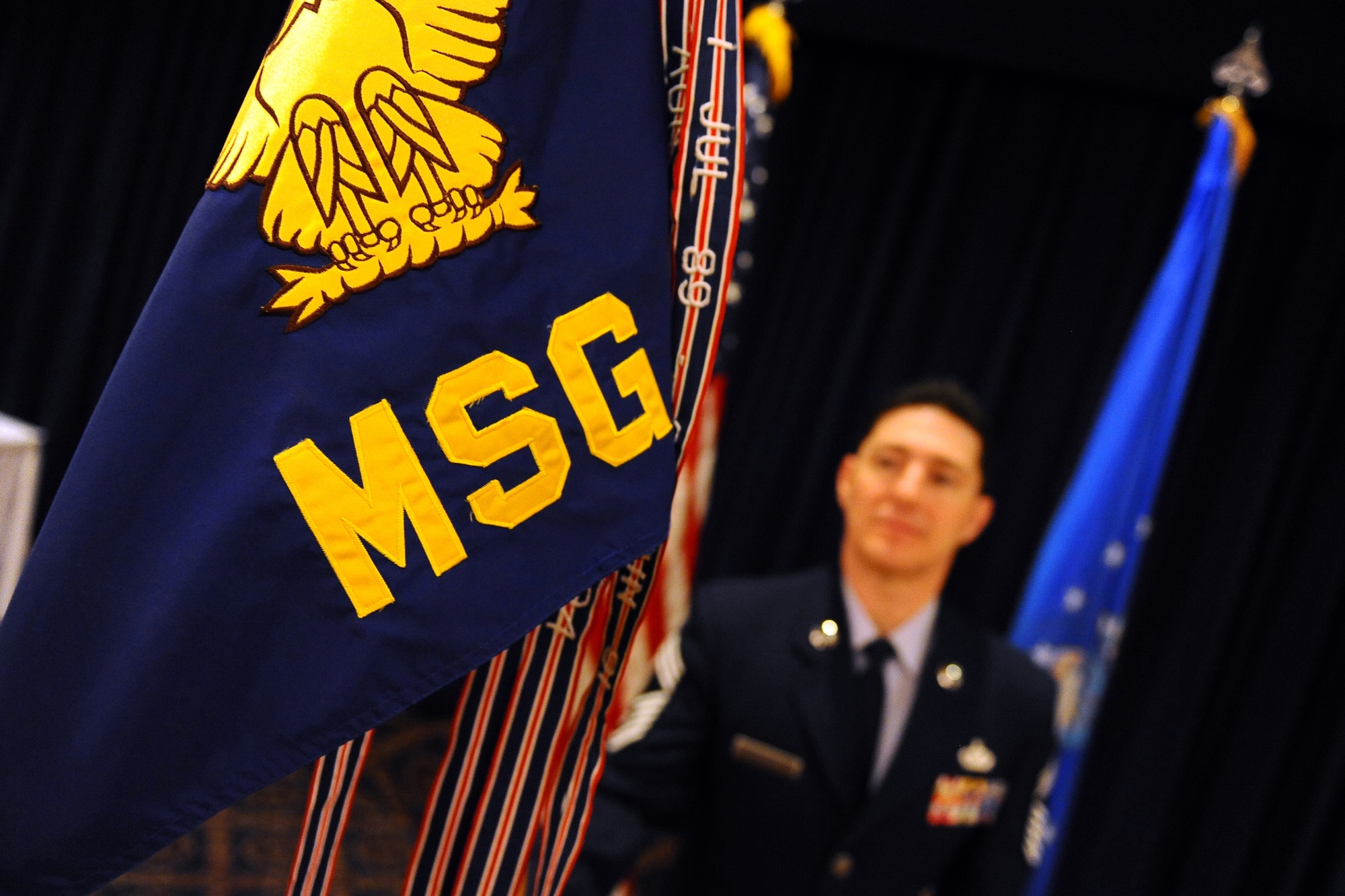 OFFUTT AIR FORCE BASE, Neb. - Chief Master Sgt. Daniel Kochera, 55th Mission Support Group, chief enlisted manager, views the 55th MSG guidon during the change of command ceremony held here at the Patriot Club, May 19.

U.S. Air Force Photo by Josh Plueger