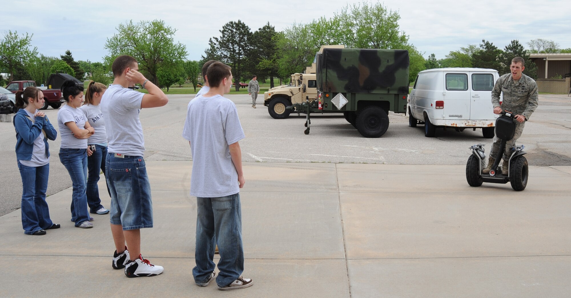 MCCONNELL AIR FORCE BASE, Kan. -- Airman Graham Horner, 22nd Civil Engineer Squadron, demonstrates the use of a Segway for Crooked Oaks High School cadets during a base tour, May 14. The suit explosive ordnance disposal Airmen use can weigh up to 90 pounds, hindering their ability to walk even short distances. Therefore, they ride a Segway while wearing the suit to reduce travel time. (Photo by Senior Airman Laura Suttles)