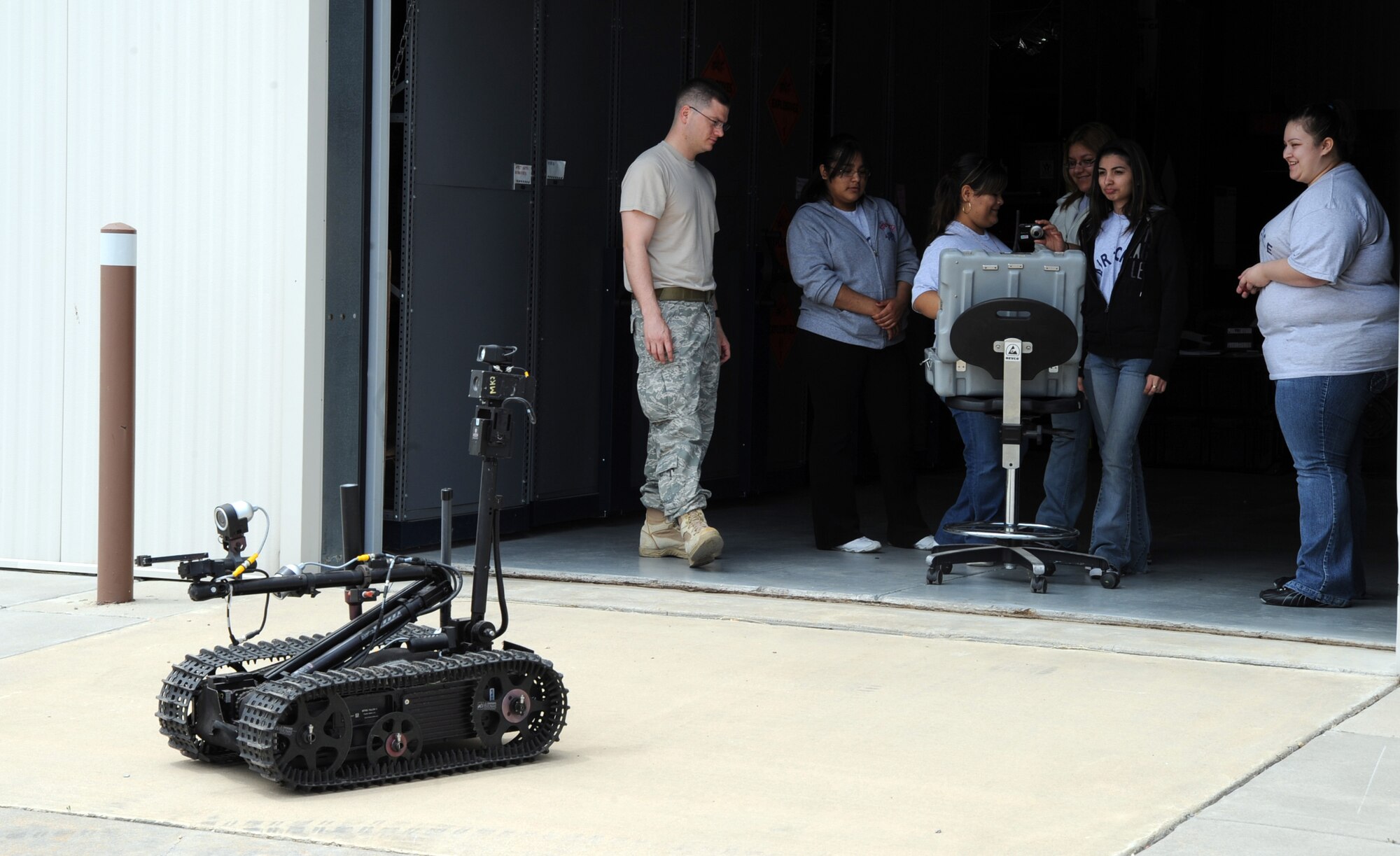 MCCONNELL AIR FORCE BASE, Kan. -- Senior Airman Shane Baze, 22nd Civil Engineer Squadron, lets Crooked Oak High School Junior Reserve Officer Training Corps cadets take turns operating the Talon Robot, during a base tour, May 14. The robot decreases fatalities by retrieving and analyzing suspicious materials that have the possibility of being harmful to humans. (Photo by Senior Airman Laura Suttles)