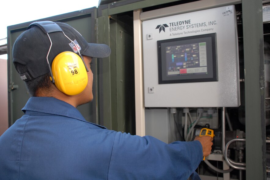 HICKAM AIR FORCE BASE, Hawaii – Chris Gaje, Hydra FLX Systems hydrogen station operator from Houston, Texas, checks the temperature on an electrolyzer here May 13. The electrolyzer uses water (H2O) and electricity from the inverter box to flash boil water so hot and so fast that the hydrogen and oxygen atoms in the water split to make pure hydrogen. The hydrogen provides non-petroleum-based power for vehicles The first hydrogen-powered vehicle here was developed in 2003, and because the hydrogen plant is now powered by the solar array they have achieved a major demonstration milestone in the program. (U.S. Air Force photo by Senior Airman Carolyn Viss)
