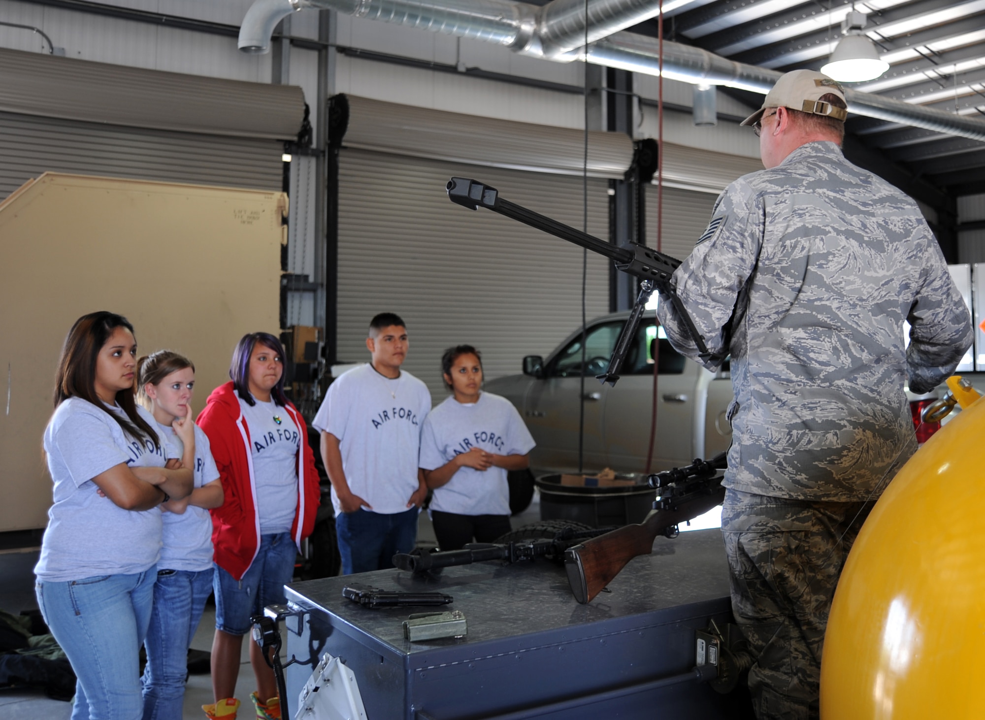 MCCONNELL AIR FORCE BASE, Kan. -- Tech Sgt. Phillip Hauser, 22nd Civil Engineer Squadron, teaches Junior Reserve Officer Training Corps cadets from Crooked Oak High School about explosive Ordnance disposal weapons during a base tour, May 14. Sergeant Hauser briefed about how to use certain weapons downrange and the impact they can have. (Photo by Senior Airman Laura Suttles)
