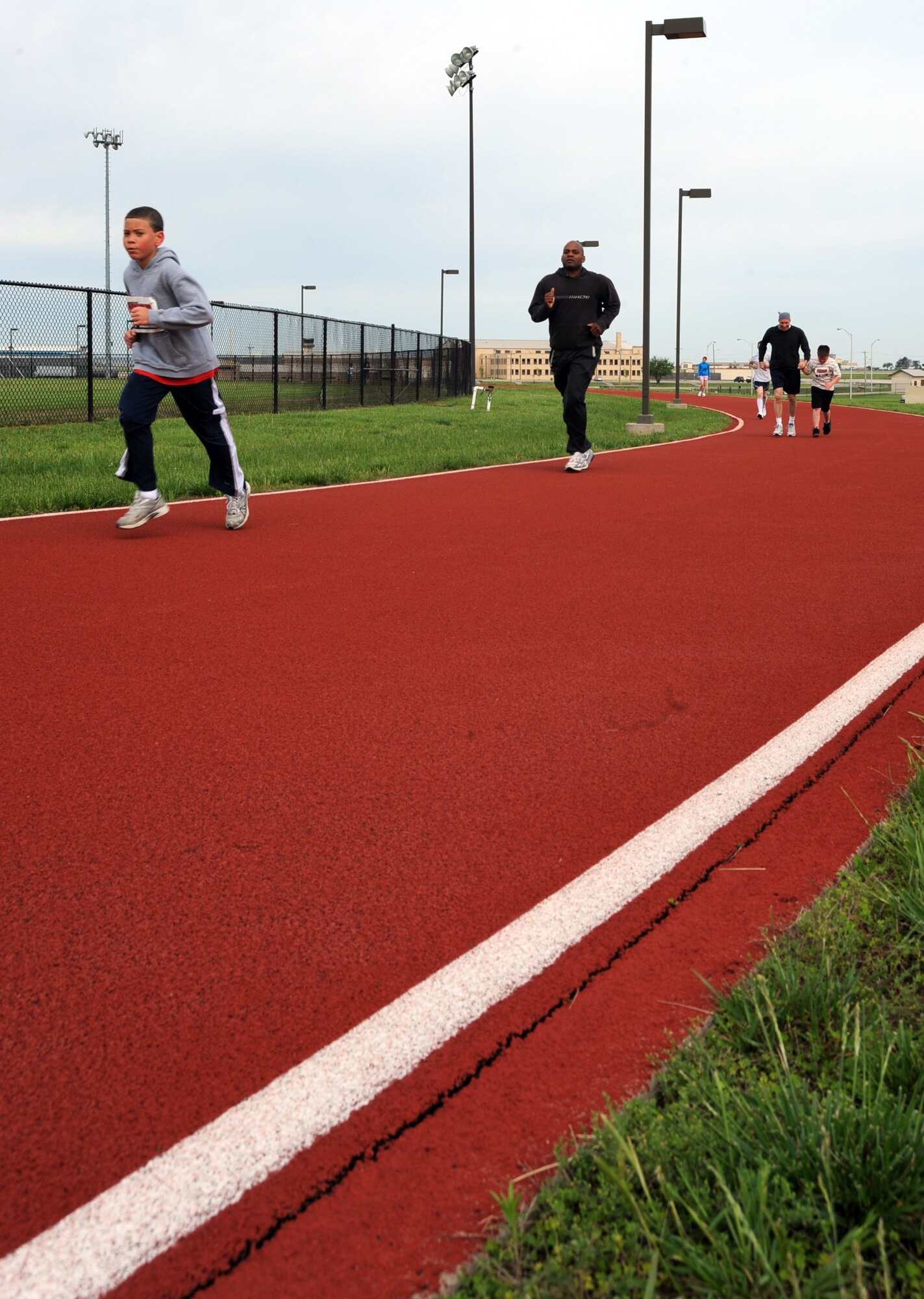 MCCONNELL AIR FORCE BASE, Kan. -- Members of Team McConnell join together for a fun run on the base track, May 16. The fun run provided a family building exercise as well as improved morale for all participants. (Photo by Senior Airman Laura Suttles)