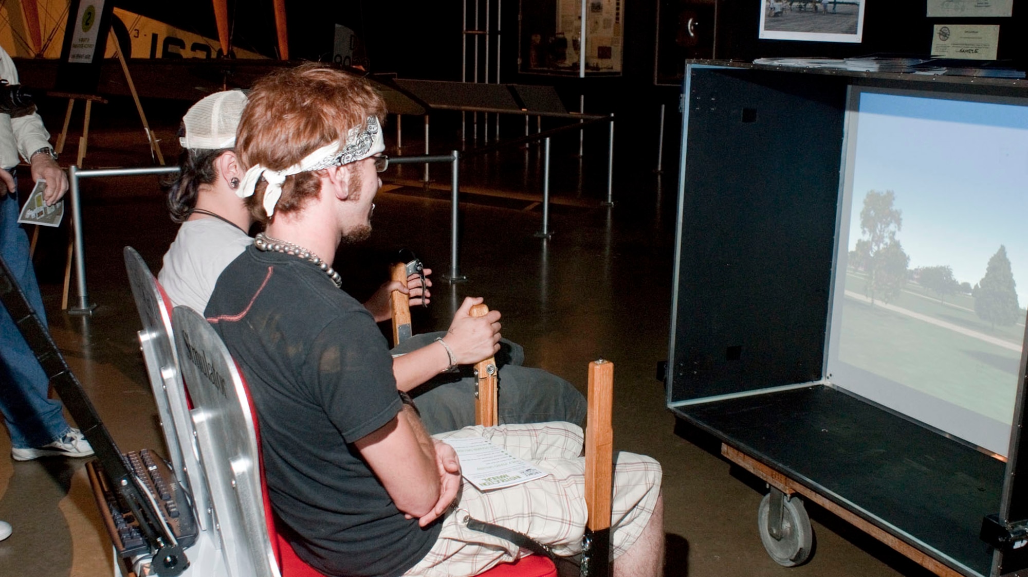 Visitors tried their hand at flying a Wright B Flyer during Night at the Air Force Museum May 15 at the National Museum of the U.S. Air Force in Dayton, Ohio. (U.S. Air Force photo/Dick Brice) 
