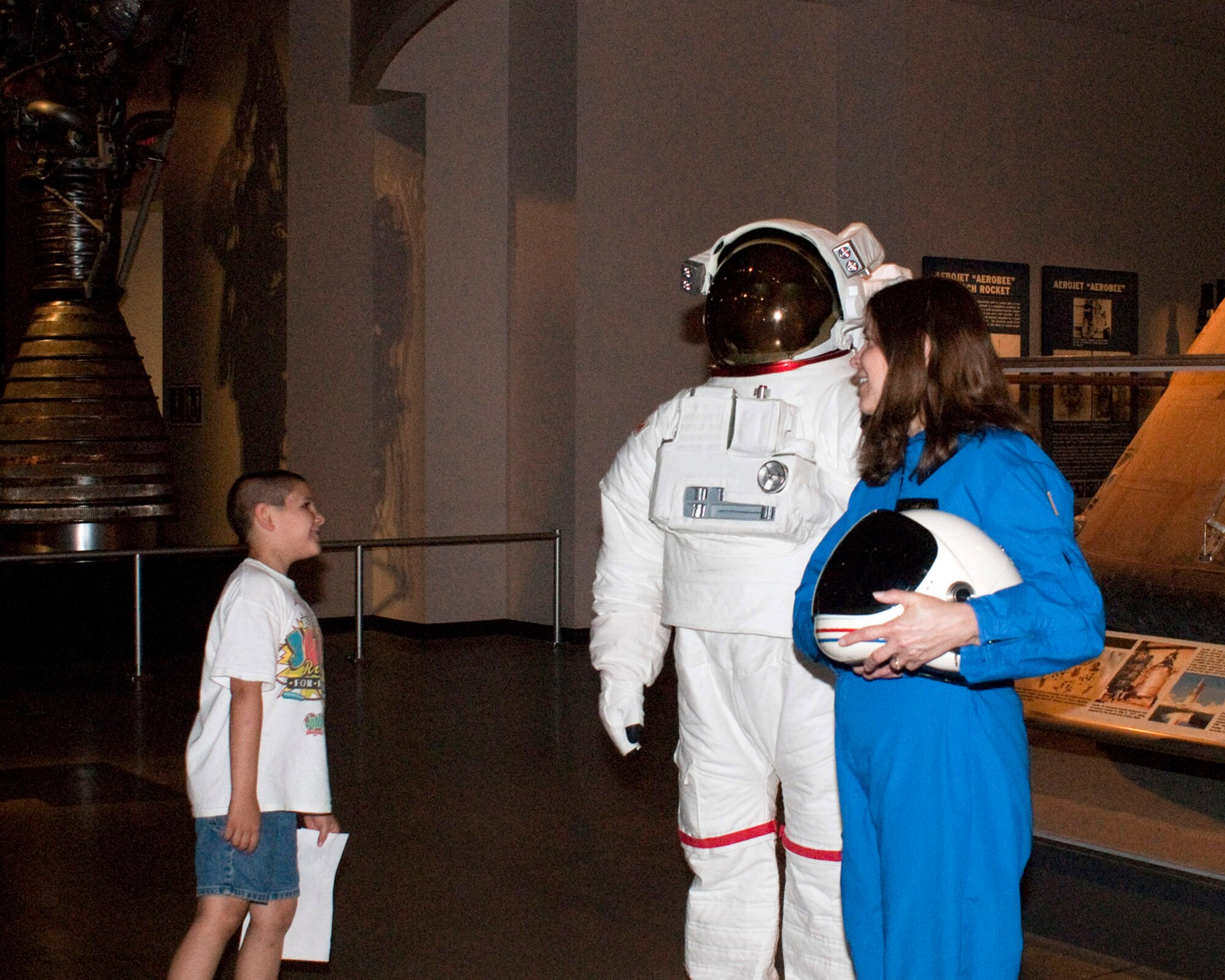 A visitor checks out two astronauts during Night at the Air Force Museum May 15 at the National Museum of the U.S. Air Force in Dayton, Ohio. (U.S. Air Force photo/Dick Brice)