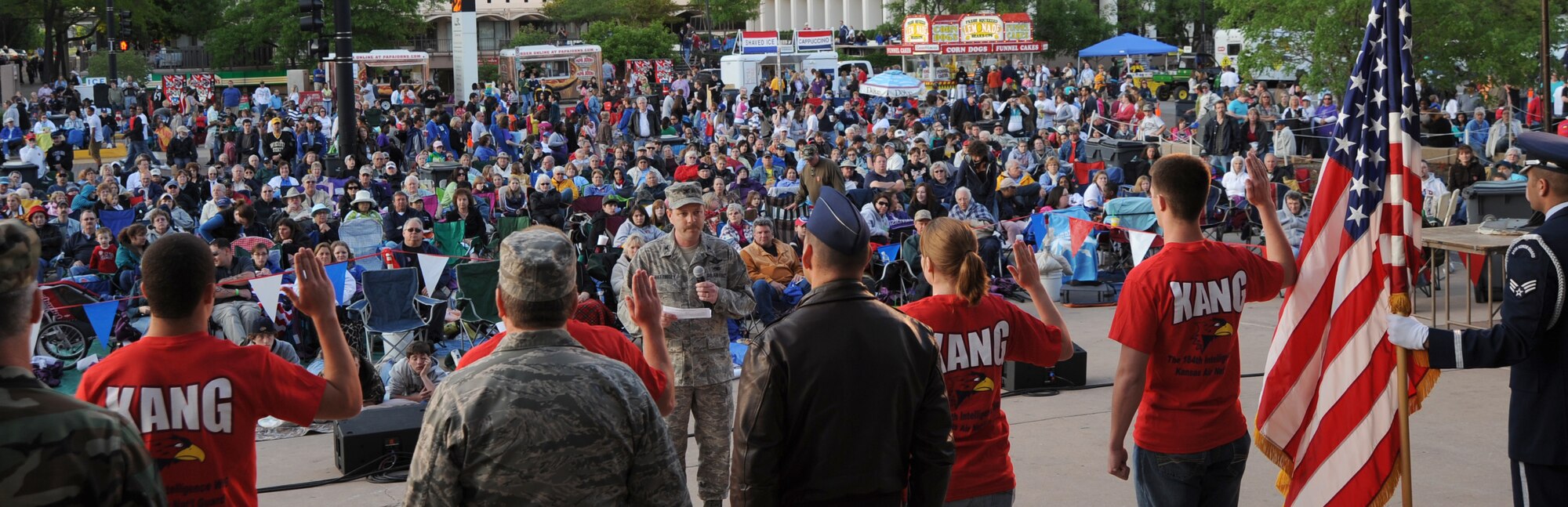 MCCONNELL AIR FORCE BASE, Kan. -- Col. Leonard Mattingly, 184th Intelligence Wing vice commander, swears in new Kansas Air National Guard recruits during the Wichita River Festival in front of Century II downtown Wichita, May 16. The River Festival was established in 1972 and is the biggest annual event in the Midwest during May according to www.wichitariverfestival.com/history.cfm. (Photo by Senior Airman Roy Lynch) 