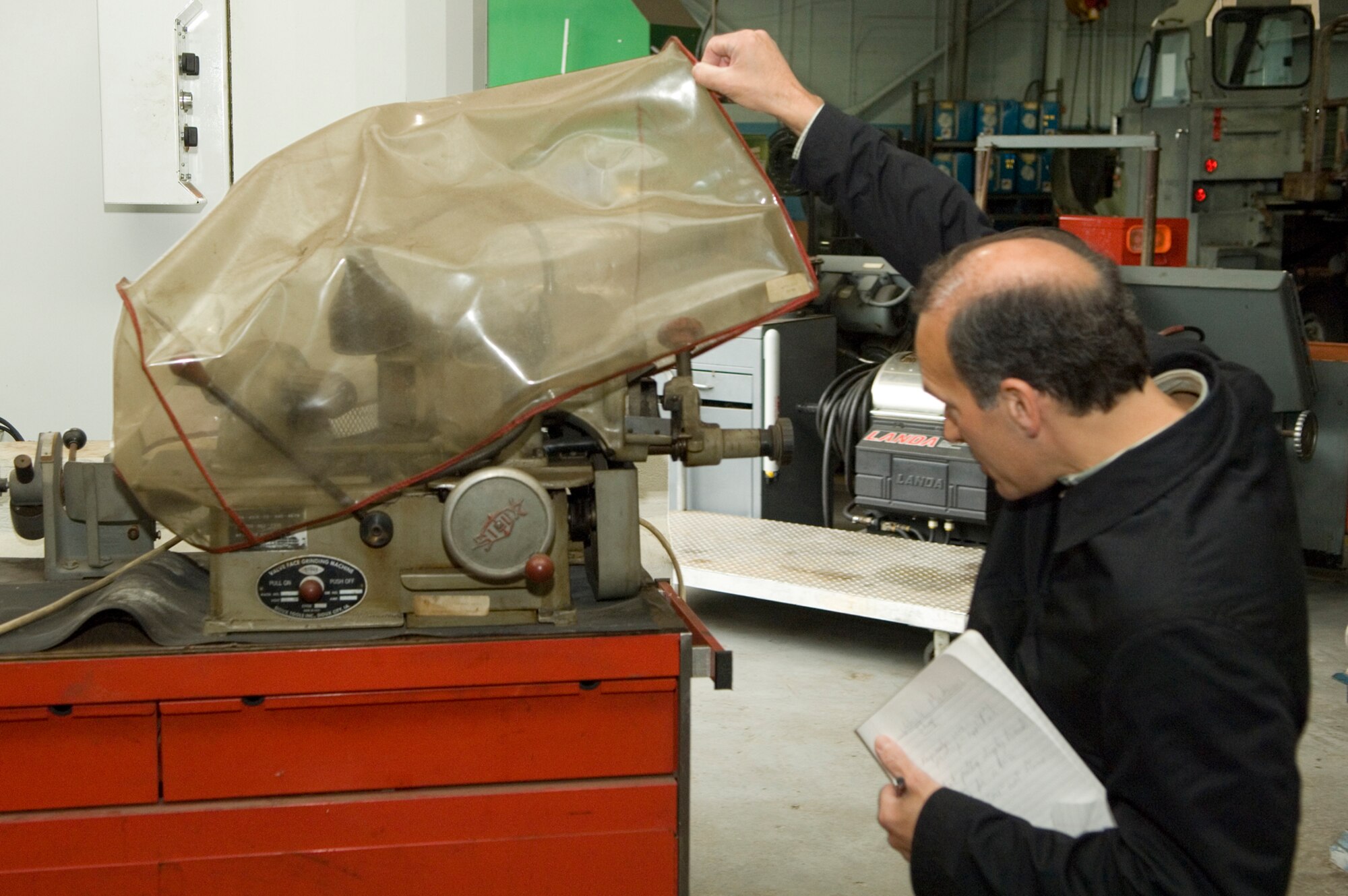 HANSCOM AIR FORCE BASE, Mass. –Dan Montanaro, Occupational Safety and Health Administration auditor, inspects a piece of equipment at the base’s Transportation Maintenance facility during Hanscom’s Voluntary Protection Program audit May 18. A team of OSHA auditors are inspecting Hanscom’s program to determine if the base has met the requirements to become the first Air Force installation to earn VPP certification.  (U.S. Air Force photo by Mark Wyatt)