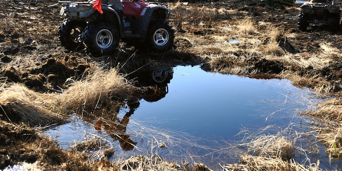 Airman 1st Class Brandon Wood uses an all-terrain vehicle to cover more ground in search of inert and live ordnance on the Yukon training area May 14 at Eielson Air Force Base, Alaska. The 354th Civil Engineer Squadron Explosive Ordnance Disposal shop mission is to remove hazardous ordnance and munitions residue from bombing and gunnery ranges, which allows target maintenance personnel to perform upkeep and reorganize target arrays. Airman Wood is assigned to the 354th CES EOD shop. (U.S. Air Force Photo/Senior Airman Jonathan Snyder) 