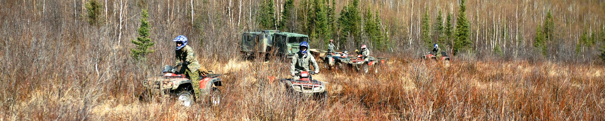 Air Force and Marine Explosive Ordnance Disposal personnel using all-terrain vehicles' span out to cover more ground on the Yukon training area on the Joint Pacific Alaskan Range Complex May 14, 2009, Eielson Air Force Base, Alaska. The 354th Civil Engineer Squadron EOD shop, with the help of 60th EOD, Travis Air Force Base, Cali., 509th EOD Whiteman Air Force Base, Mo., and Marines from the 1st EOD Company, Camp Pendleton, Cali., clear 10,000 acres of land of hazardous inert and live ordnance.  (U.S. Air Force Photo/Senior Airman Jonathan Snyder)