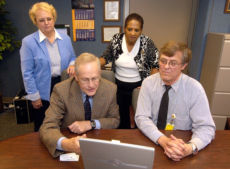 Carole Wanish, small business specialist, and Joanne Davis, Small Business Office director, look on as retired Lt. Gen. Bill Hallin, the executive consultant for Joining Technologies Inc., in East Granby, Conn., speaks with Joe Roop, source development specialist about opportunities at Tinker. (Air Force photo/Margo Wright)