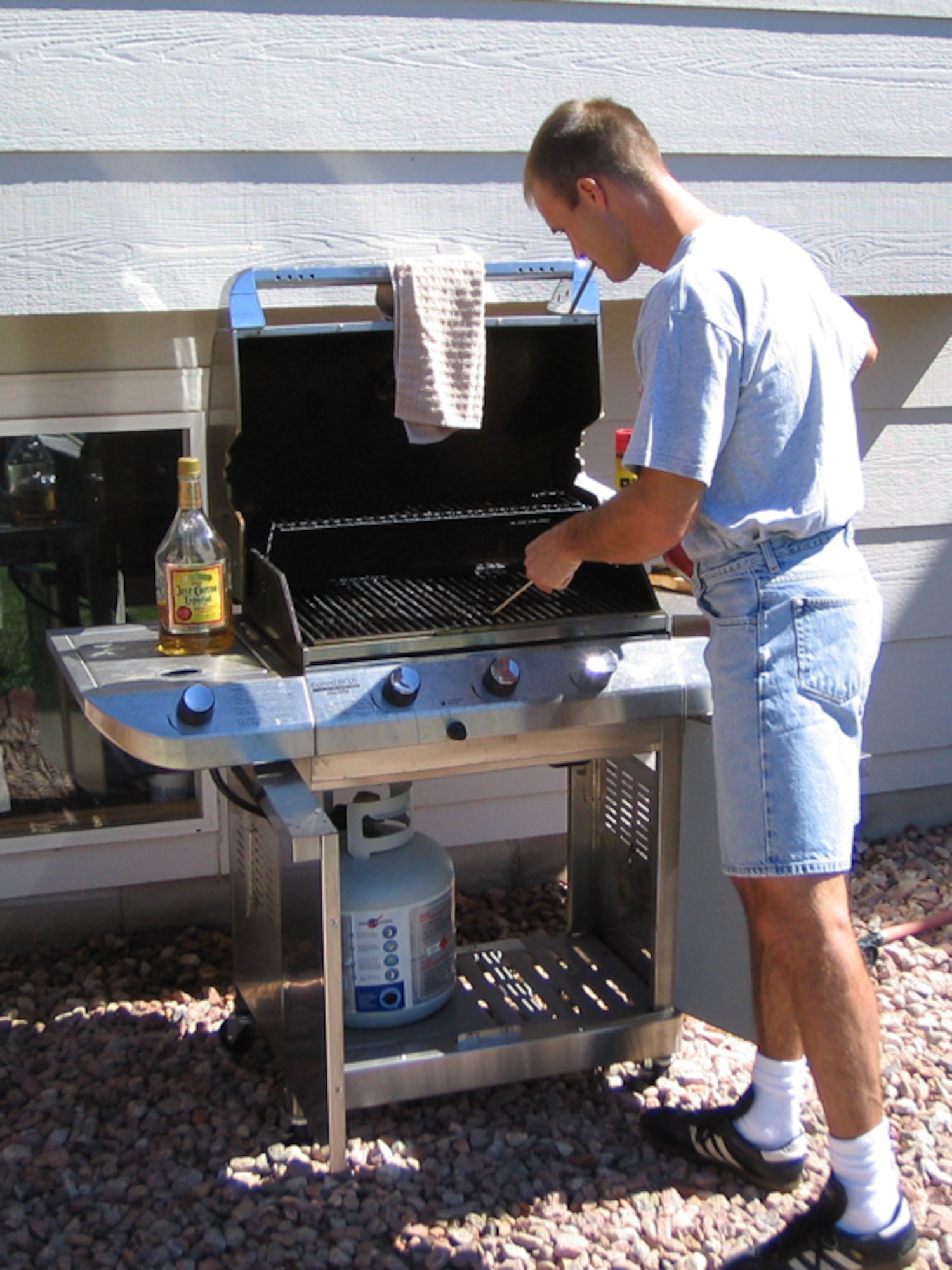 While barbecues provide a fun and casual dining experience, they also provide the ideal conditions for a costly mishap. Keep the grill off wooden decks and away from children's play areas and low-hanging tree branches. (U.S. Air Force file photo)