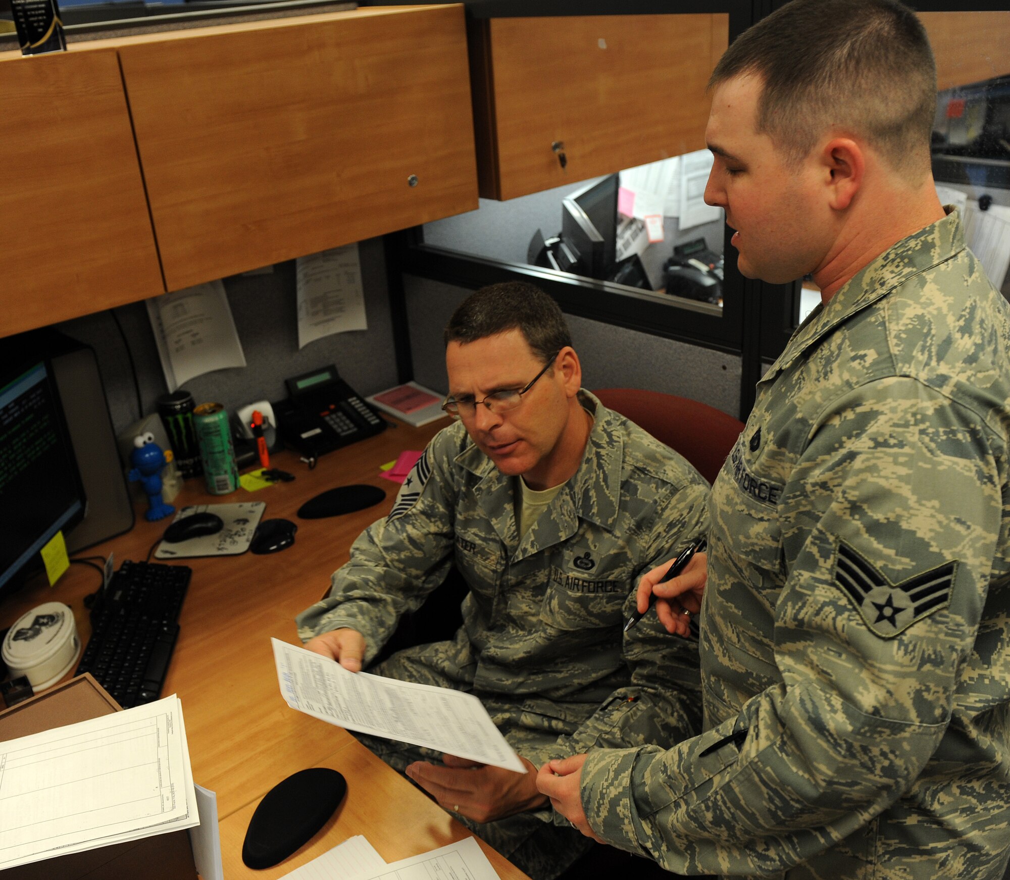 LANGLEY AIR FORCE BASE, Va. -- Senior Airman Jonathan Davis, 1st Comptroller Squadron lead customer service technician, explains a section of a finance document to Command Chief Master Sgt. Kevin Slater May 19.  Chief Slater spent the morning working side-by-side with Airman from the 1st Comptroller Squadron.  (U.S. Air Force photo/Airman 1st Class Zachary Wolf)
