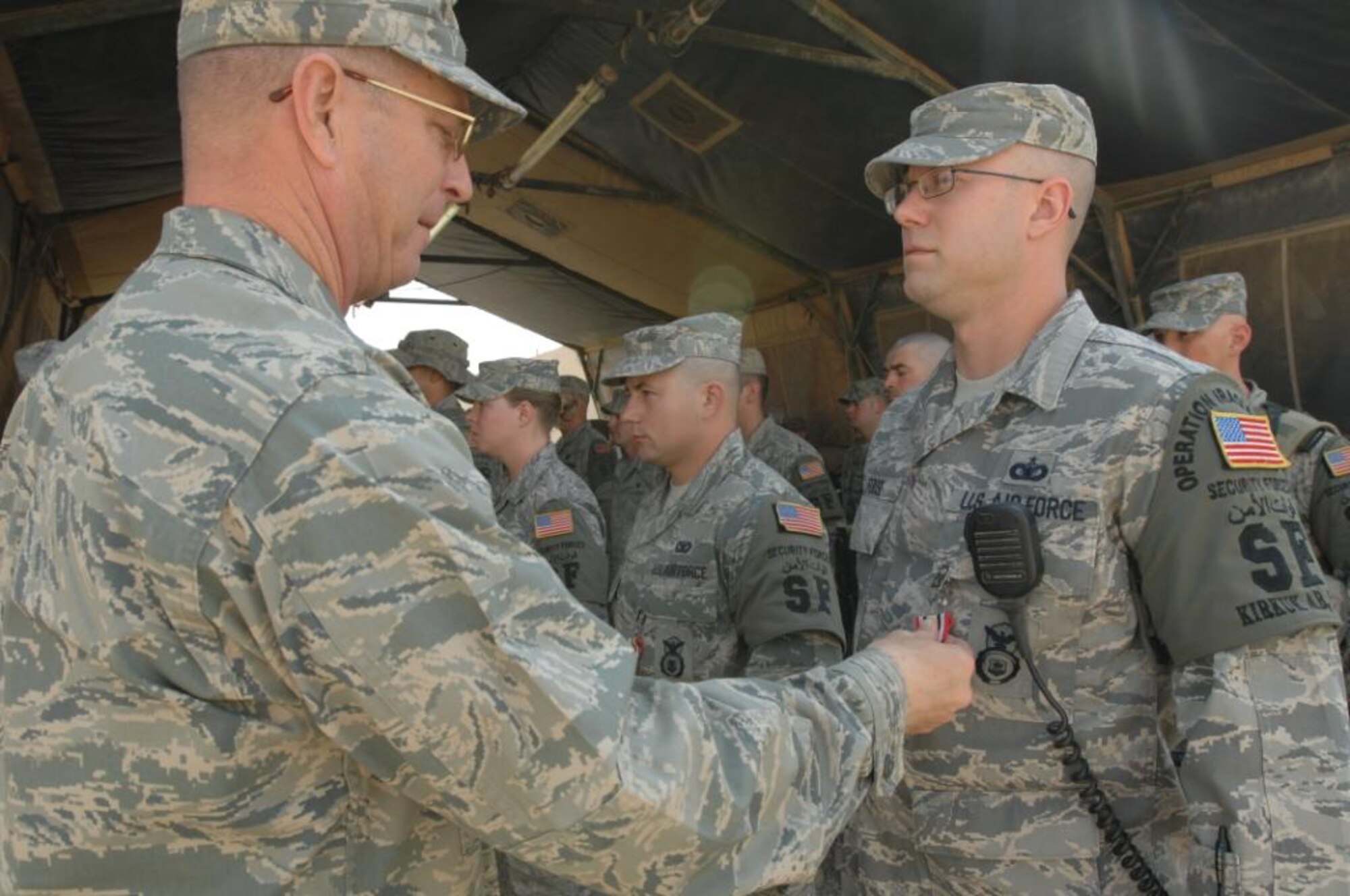 Staff Sgt. Nathan Foose, 512th Security Forces Squadron, is awarded the Iraqi Campaign Medal while assigned to the 506th Expeditionary Security Forces Squadron, Kirkuk Air Base, Iraq. Sergeant Foose is part of a 13-person team deployed from here in support of the war effort. Col. Cary Conners, 506th ESFS commander, pinned on the medal May 14. (U.S. Air Force photo)
