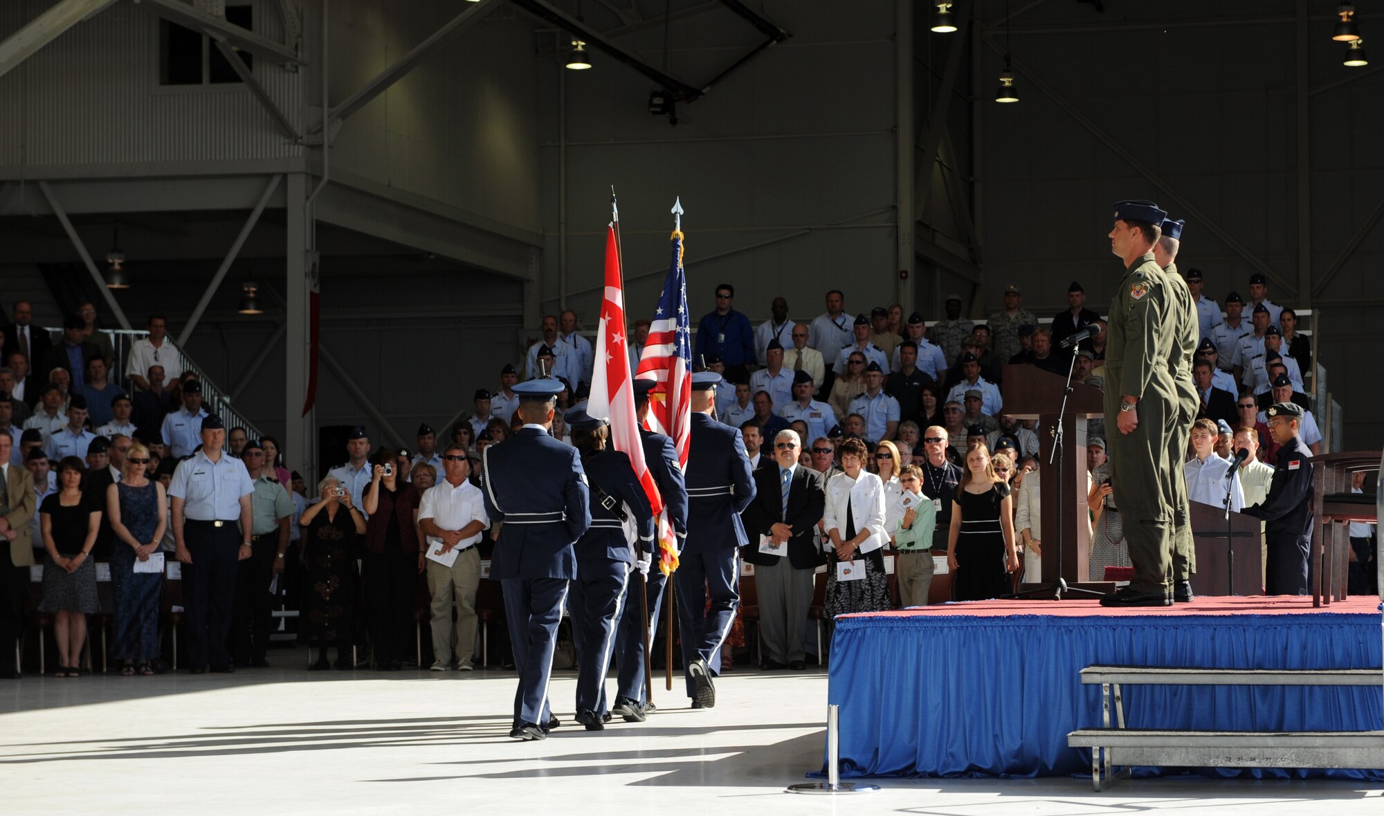 MOUNTAIN HOME AIR FORCE BASE, Idaho -- Col. James McGovern, 366th Operations Group commander, and Lt. Col. Keith Gibson, 428th Fighter Squadron commander, stand at attention as the base honor guard retires the colors during the 428th FS reactivation and assumption-of-command ceremony May 18. The U.S. Air Force reactivated the 428th FS here as part of the Peace Carvin V program -- an international partnership between the United States and Republic of Singapore. The combined U.S. Air Force and Republic of Singapore air force unit will train RSAF aircrews in F-15SG fighters. (U.S. Air Force photo by Airman 1st Class Debbie Lockhart)