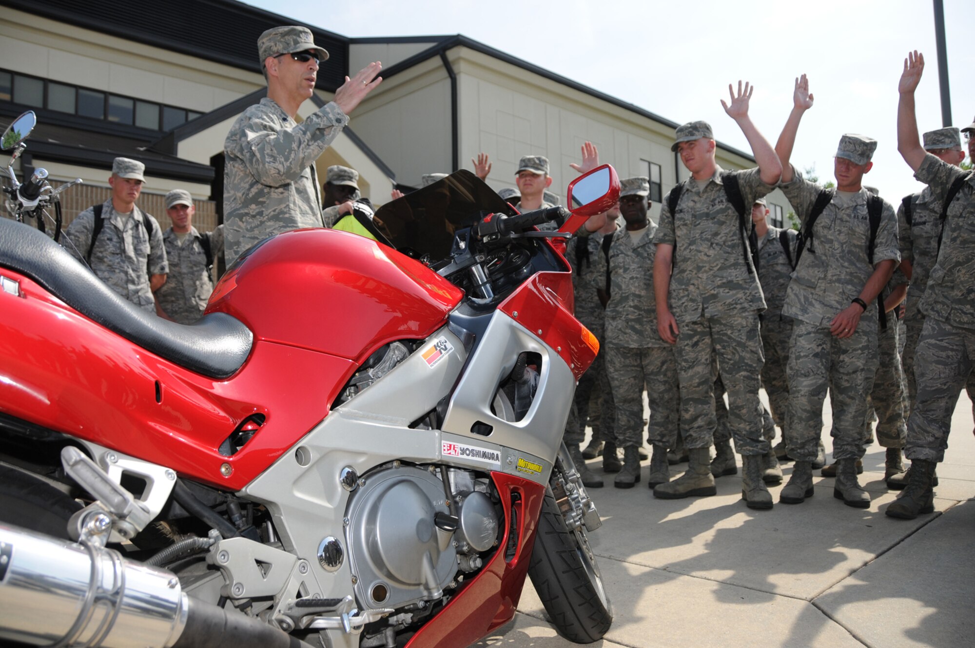 Lt. Col. John Thomas, 338th Training Squadron commander, briefs students from his squadron in front of Winters Manor May 13 after a motorcycle safety ride down the troop walk.  Colonel Thomas, squadron motorcycle safety representatives, instructors, military training leaders and other members of the training staff rode a variety of motorcycles to share biking experiences and to increase awareness of motorcycle training requirements and safety gear.  The message conveyed was that motorcycling is fun, enjoyable and economical, but comes with its own unique set of risks, said Don Lindsey, one of the squadron’s cycling enthusiasts.  (U.S. Air Force photo by Kemberly Groue)