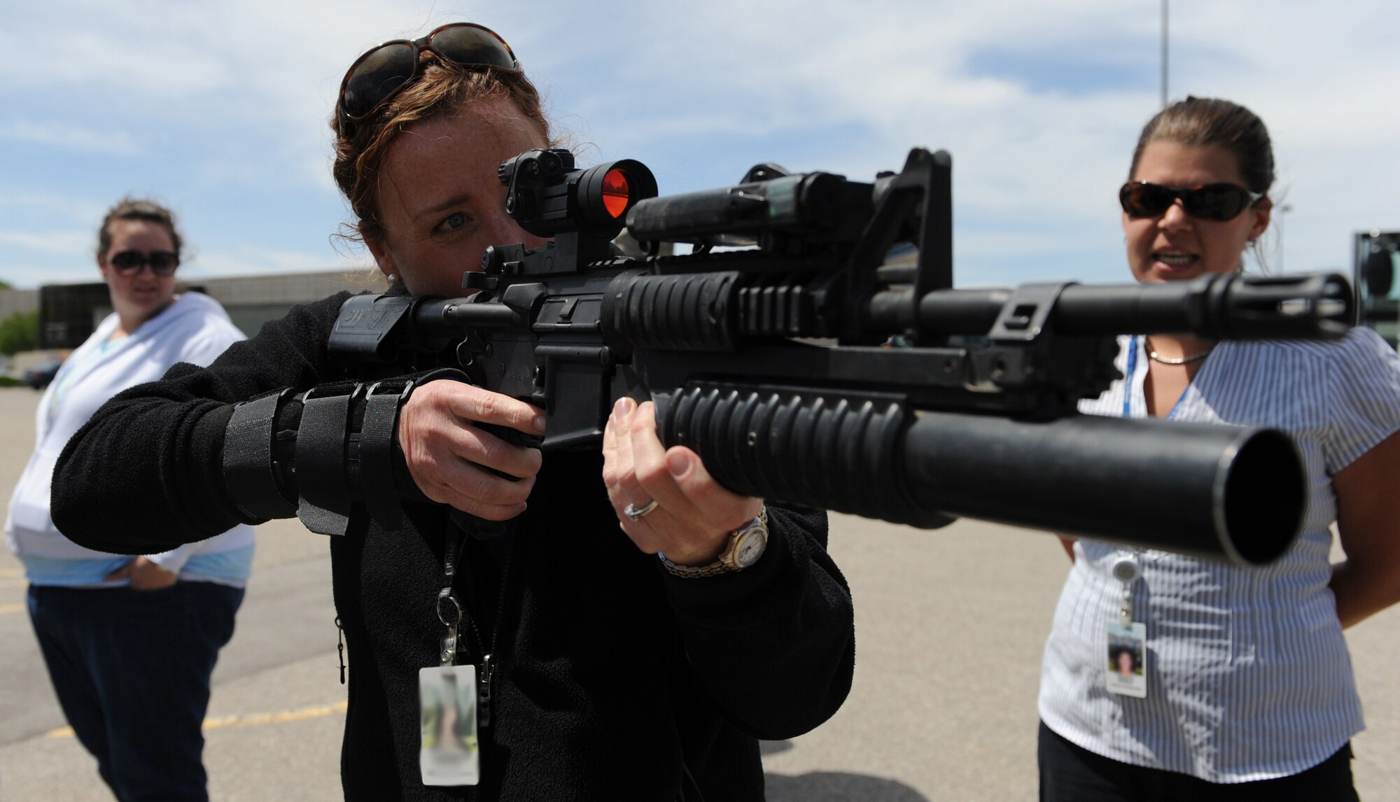 MOUNTAIN HOME AIR FORCE BASE, Idaho -- Emily Kovarik holds an M-203 Grenade Launcher during the 366th Security Forces Squadron weapons display at the Base Exchange May 13 in appreciation of National Police Week. The week honors personnel in law enforcement and pay tribute to those who gave their lives while serving their community.  (U.S. Air Force photo/ Airman 1st Class Renishia Richardson)