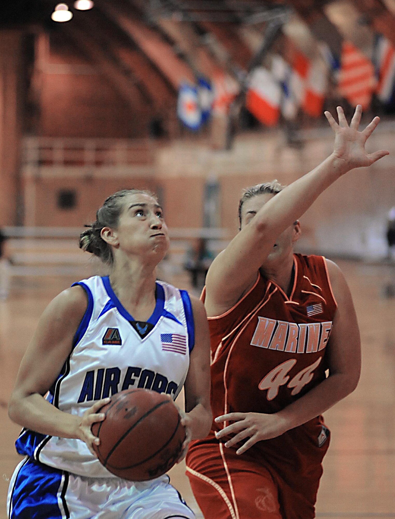 Senior Airman Jennifer McClure takes the ball to the basket for two points during a basketball game against the Marine Corps during the Armed Forces Basketball Championship.  The Air Force women won the game.  The tournament ran from May 12 to 17 at the Naval Support Activity Mid-South in Millington, Tenn.  (U.S. Navy photo/Petty Officer 1st Class John Collins)