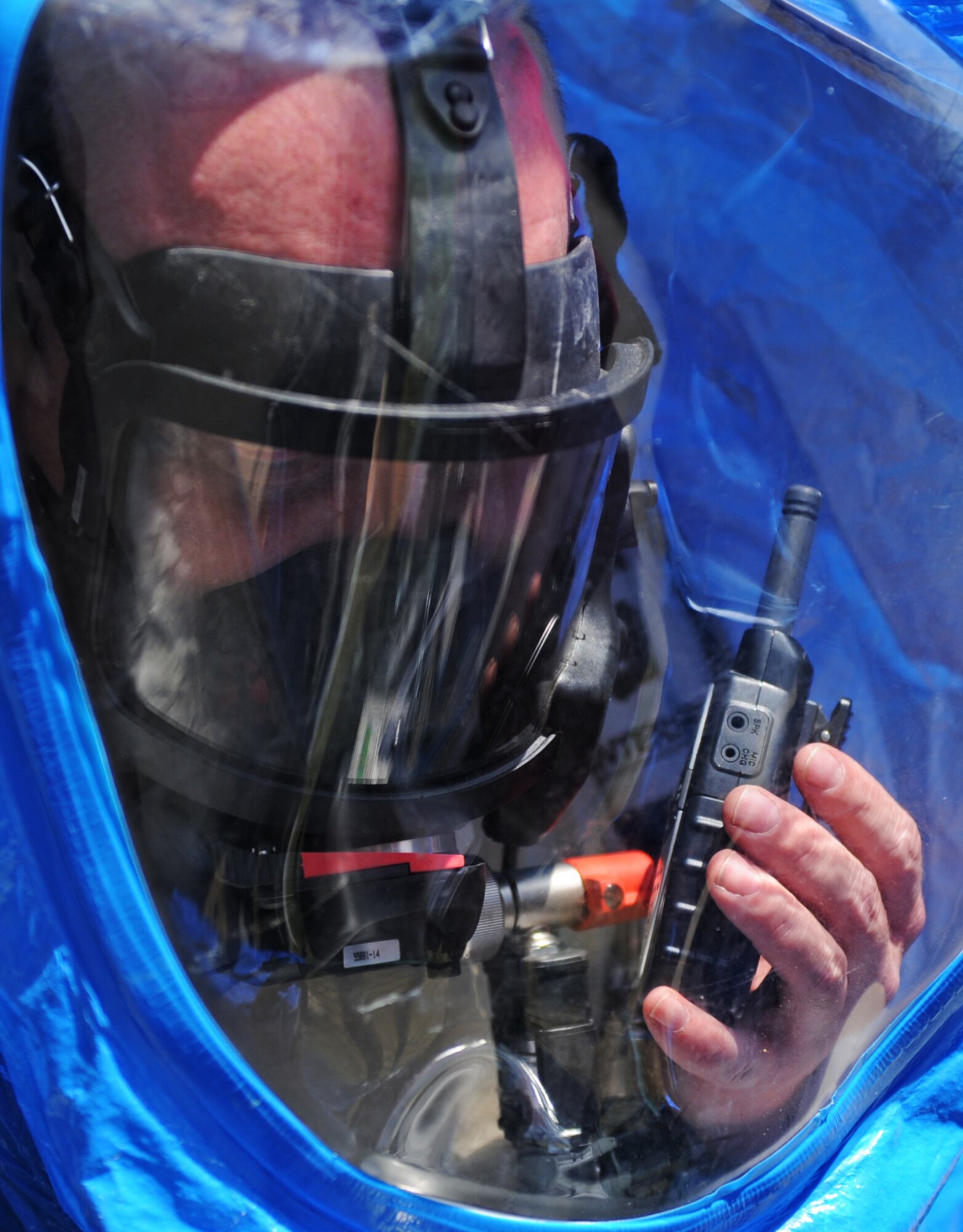 MOUNTAIN HOME AIR FORCE BASE, Idaho -- Tech. Sgt. Kiley Davis, 366th Aerospace Medicine Squadron bioenvironmental engineer technician, calls back to the mobile command trailer informing the commander they are entering the contaminated building May 12. The bioenvironmental engineer flight is participating in the Air Combat Command chemical, biological, radiological, nuclear and high yield explosive (CBRNE) challenge, which consists of several scenarios they may encounter such as a suspicious package or a chemical spill. The team will compete against other ACC bases and could then move on to compete at the Air Force level. (U.S. Air Force photo/ Senior Airman Ryan Crane)