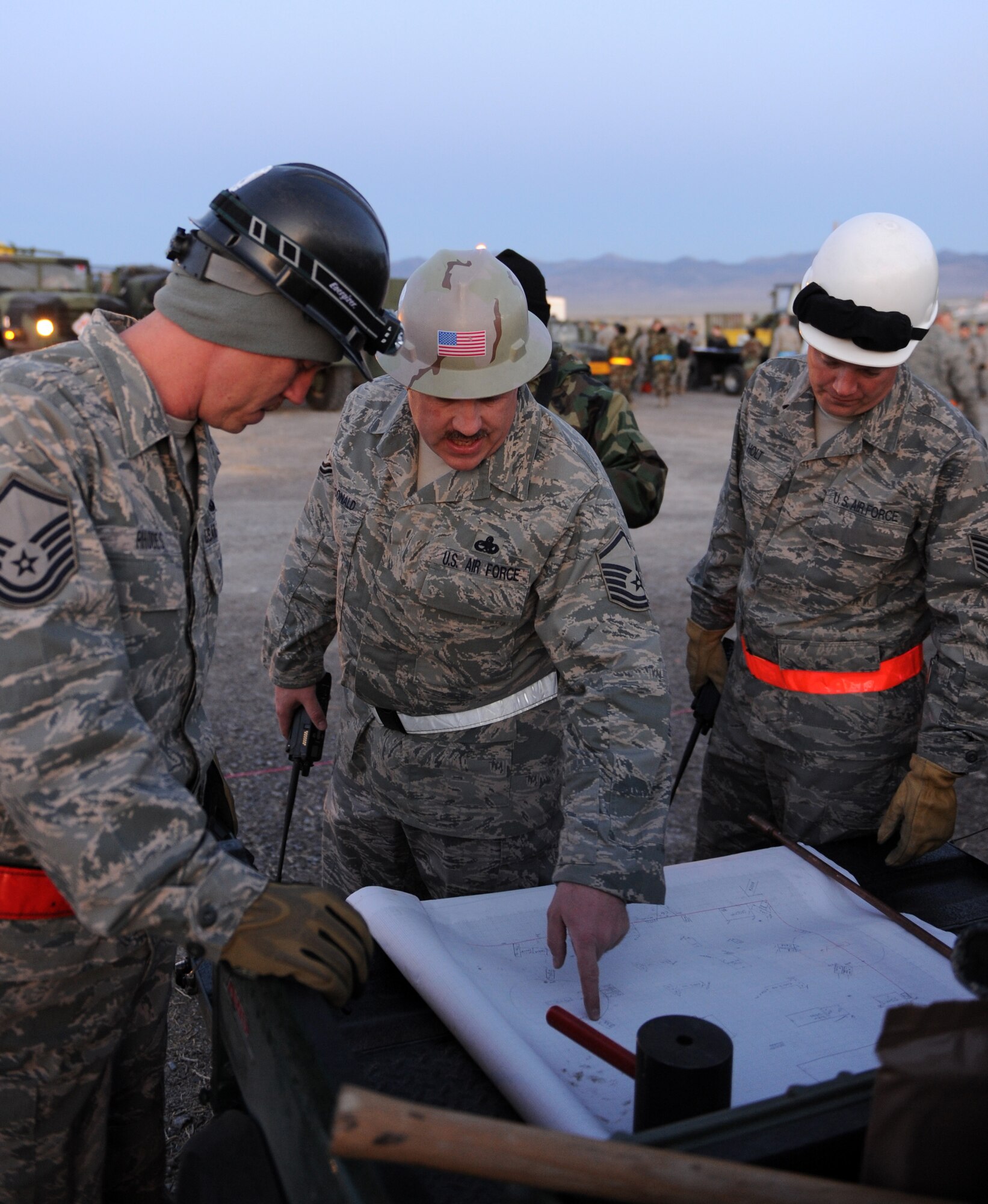 WENDOVER, Utah -- Master Sgt. James MacDonald (center), 726th Air Control Squadron beach master, discusses the layout for the training work site at Wendover, Utah, May 8 during a week-long training exercise. The 726th ACS tackles a wide-spread mission including enemy surveillance and identification, weapons control, joint and combined data-link connectivity, and battle management of offensive and defensive air activities. The squadron is made up of 27 different Air Force career fields, making it self-sustaining and able to deploy and fully operate without external support or help. (U.S. Air Force photo\Airman 1st Class Debbie Lockhart)
