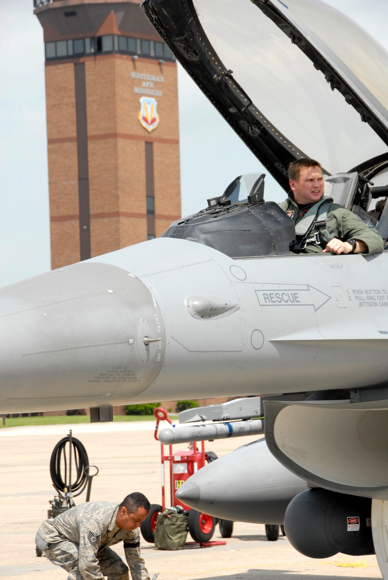 Capt. Klayton Ives, an F-16 pilot, prepares to climb out of an F-16 Fighting Falcon from the 301st Fighter Wing after landing at Whiteman Air Force Base, Mo., May 13, 2009, while Tech. Sgt. Steven Joubert prepares to secure the aircraft.  Captain Ives and other Citizen Airmen from the 301st traveled to Whiteman from Naval Air Station, Joint Reserve Base Fort Worth, Texas, to assist the 442nd Fighter Wing with an exercise May 14 to 17.  The F-16 pilots provided air-to-air agressor training for the 442nd Fighter Wing's A-10 Thunderbolt II pilots who were simulating flying combat sorties over central Missouri.  (U.S. Air Force photo/Maj. David Kurle)  
