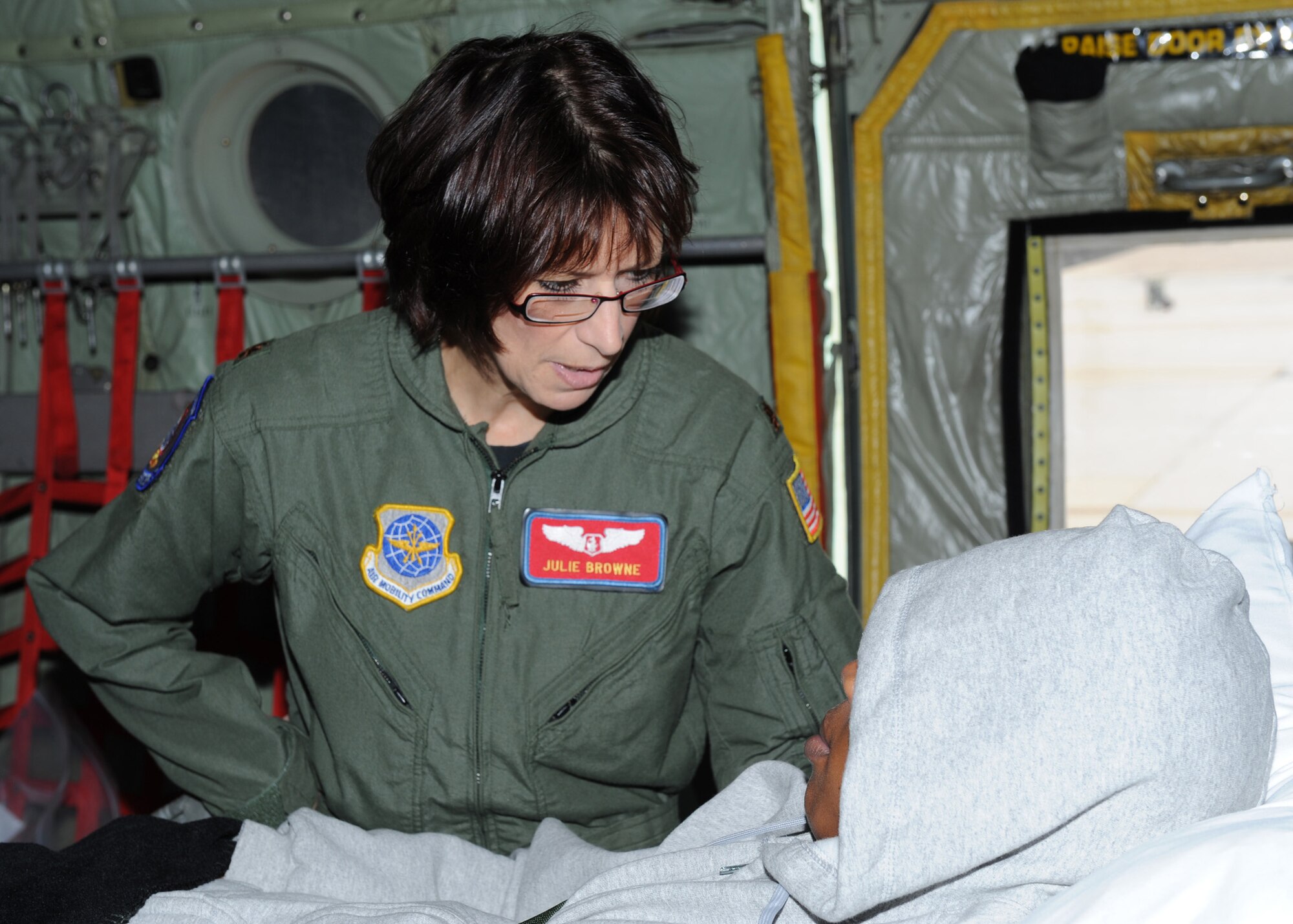 SCOTT AIR FORCE BASE, Ill. -- Maj. Julie Browne, 375th Aeromedical Evacuation Squadron medical crew director, talks with a patient regarding his condition before taking off from Scott May 18. (U.S. Air Force photo/Staff Sgt. Paul Villanueva II)