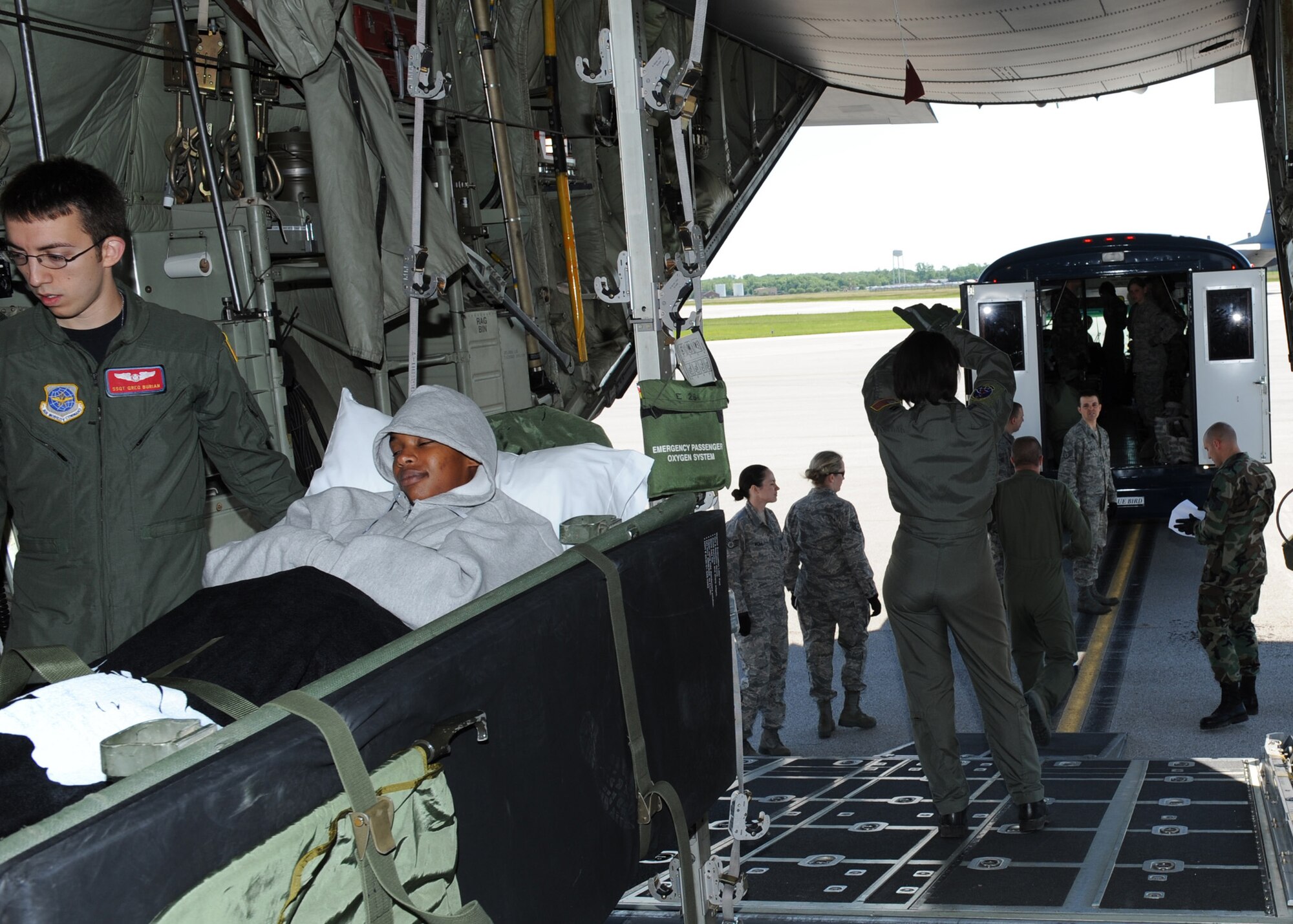 SCOTT AIR FORCE BASE, Ill. -- Members of the 375th Aeromedical Staging Facility load patients onto a C-130 Hercules at Scott May 18. Many of the patients are on the last leg of their journey home after being wounded while deployed to either Iraq or Afghanistan. While Andrews Air Force Base, Md., is typically the first stateside stop for returning patients, the Scott ASF saw an influx of patients this past weekend during the closure of the Andrews ASF for the base's airshow. (U.S. Air Force photo/Staff Sgt. Paul Villanueva II)