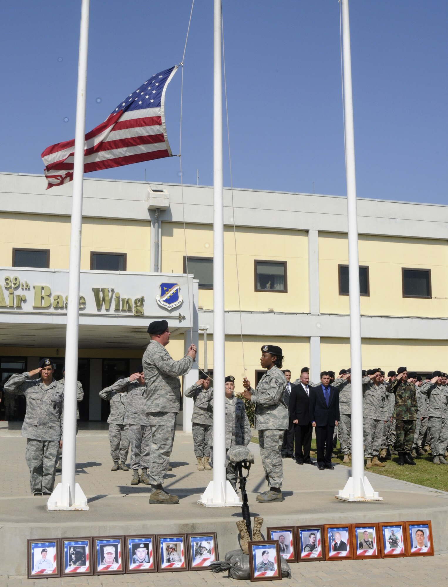 Tech Sgt. Kenneth Mitchell and Staff Sgt. Portia Wyatt, 39th Security Forces Squadron, pull the flag to half mast to give respect for fallen Air Force SF members during the Police Week retreat May 15, 2009 at Incirlik Air Base, Turkey. More than 80 SF Airmen participated in the retreat, held to finalize the end of Incirlik’s Police Week.  (U.S. Air Force photo/Airman 1st Class Amber Russell)
