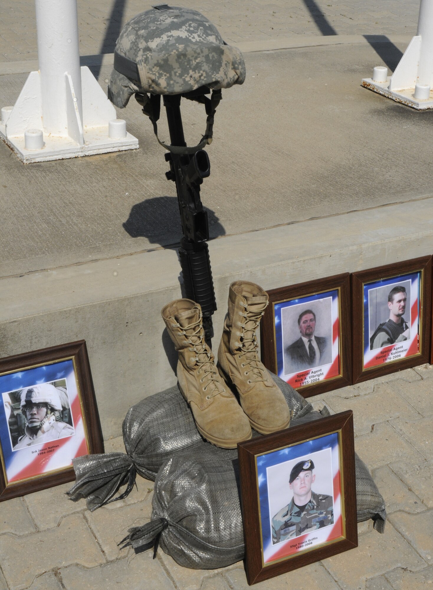 A memorial is placed at the base of the flag pole in memory of Security Forces members that have died while serving for the U.S. Air Force during the Police Week retreat May 15, 2009 at Incirlik Air Base, Turkey. More than 80 SF Airmen participated in the retreat, held to finalize the end of Incirlik’s Police Week. The flag was momentarily held at half mast to give respect to our fallen brothers.  (U.S. Air Force photo/Airman 1st Class Amber Russell)