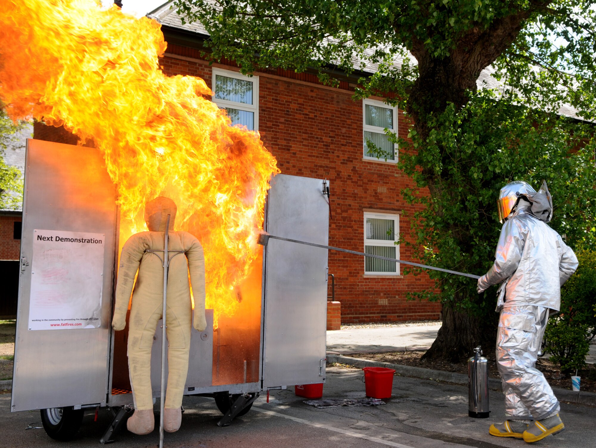 RAF Mildenhall fire fighter Simon Law shows the immediate results of pouring water on a grease fire during a safety demonstration May 19.  The fire was part of a mostly hands-on safety education event held to prepare Team Mildenhall for the upcoming 101 Critical Days of Summer.  (U.S. Air Force photo by Staff Sgt. Austin M. May)