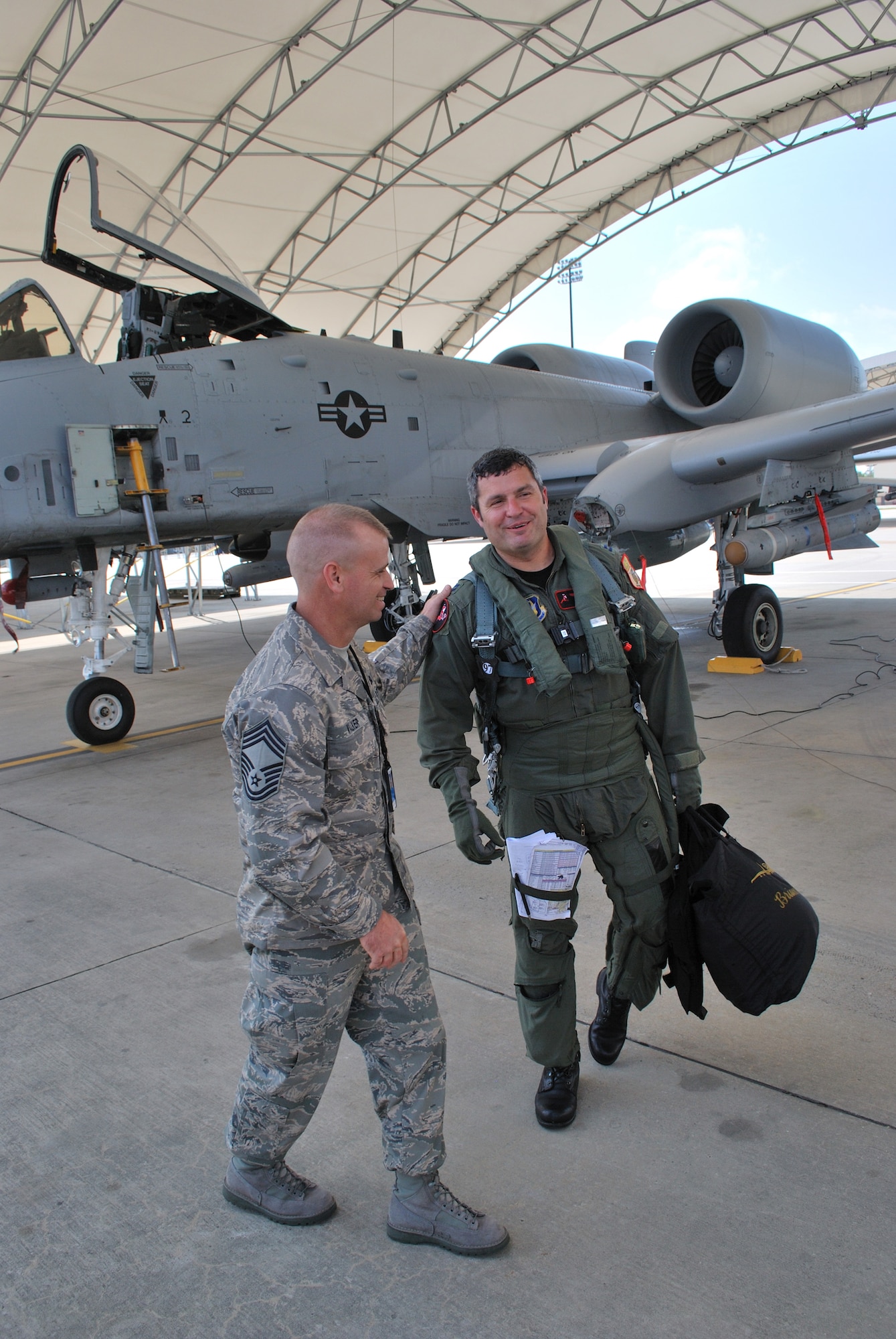 Chief Master Sgt. Stacy Walker, 476th Maintenance Squadron aircraft maintenance unit superintendant, welcomes Capt. Brian Hatch, a pilot with the 76th Fighter Squadron, after a recent flight at Moody.