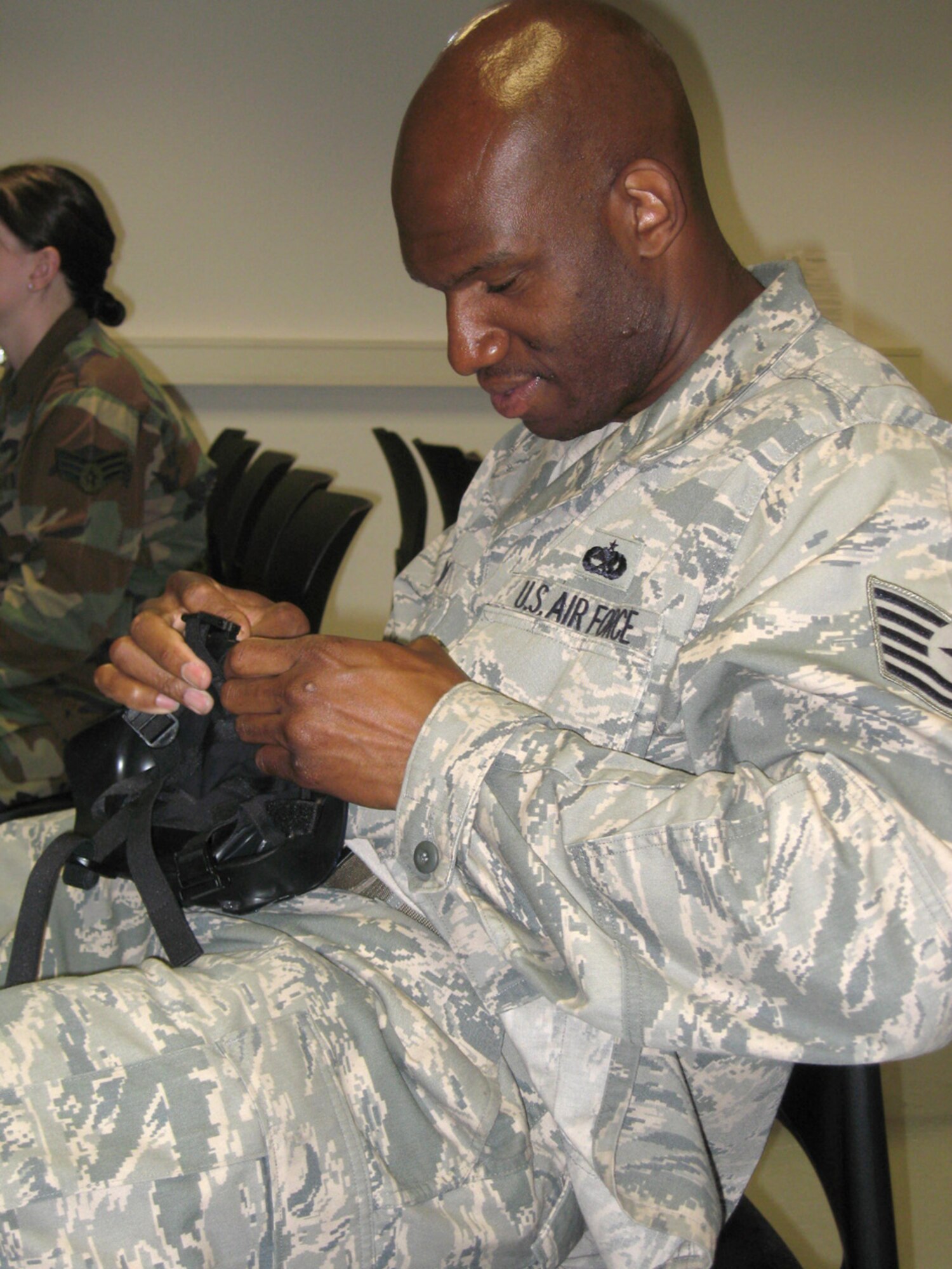 SPANGDAHLEM AIR BASE, Germany – Tech. Sgt. Corey Whitman, 52nd Equipment Maintenance Squadron, examines an M-50 gas mask he was just issued May 15, 2009. After receiving the mask Airmen were given a fit test and instruction on its proper wear. The M-50 mask offers the same level of protection against chemical, biological and radiological threats as the old style mask; however, has an improved head harness, a wider view, easier access to the drinking tube and dual filters. (U.S. Air Force photo by Tech. Sgt. Tammie Moore)