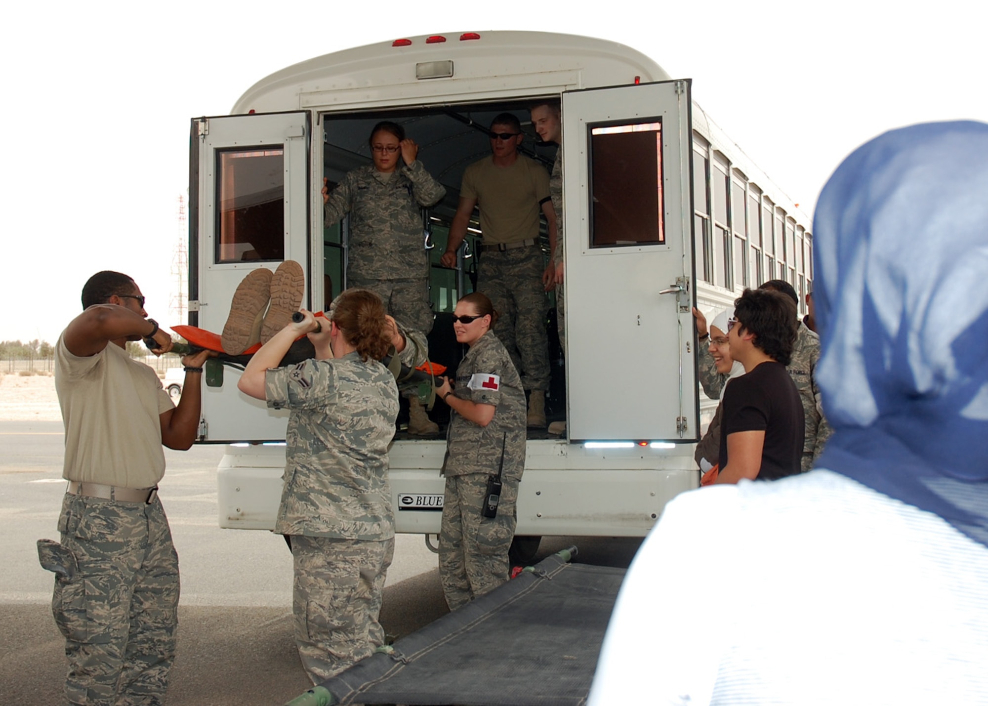 SOUTHWEST ASIA -- A student with the America-Mideast Educational and Training Services school watches members of the 386th Expeditionary Medical Group demonstrate an aeromedical staging mission during the school's visit to the 386th Air Expeditionary Wing May 16. The students were treated to a C-130 static display, a working dog demonstration and had lunch with Airmen during the school's first and only visit to the air base. (U.S. Air Force photo by Capt. Angelic Dolan)