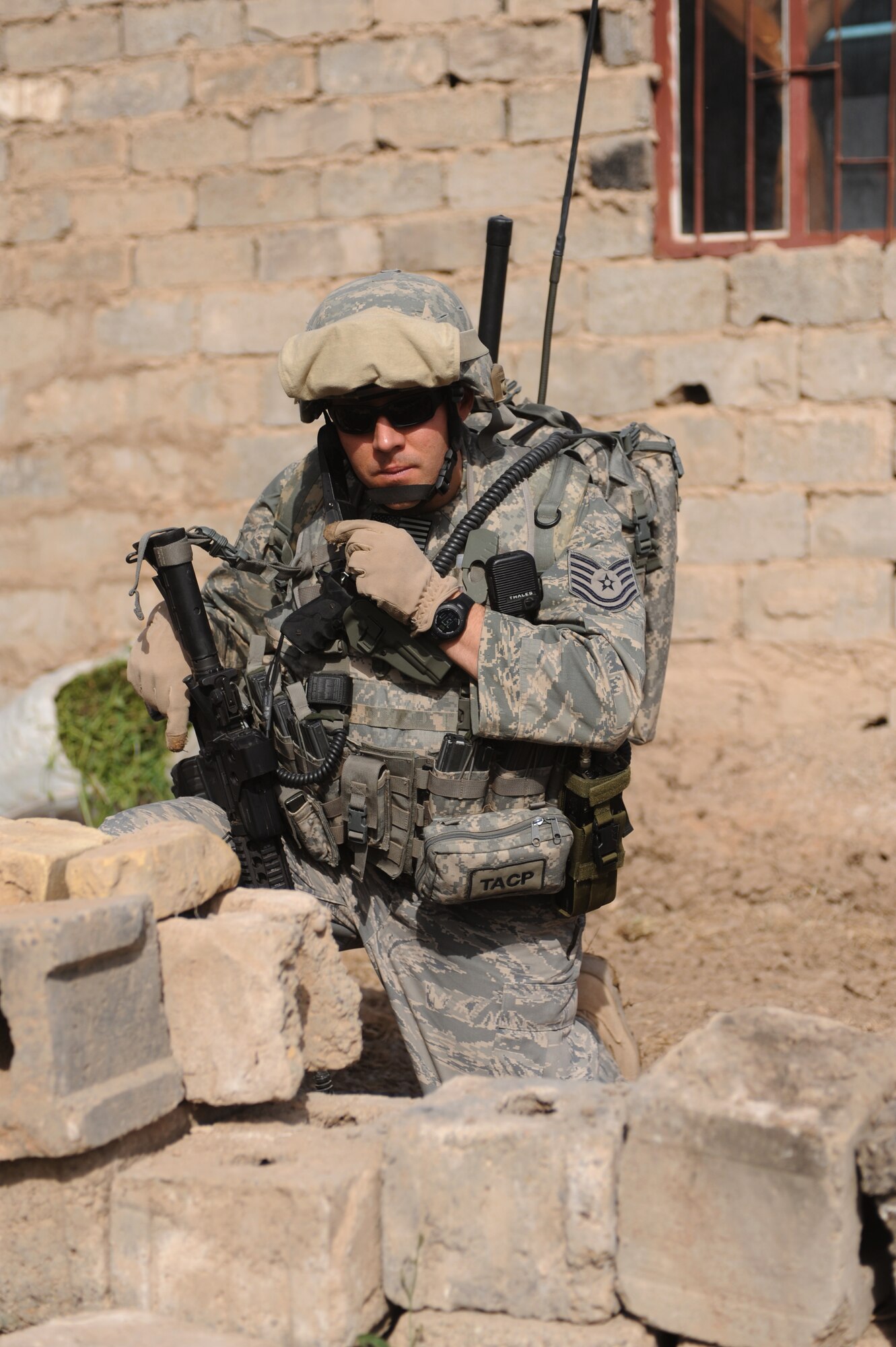 Tech. Sgt. Beiuterman Jenkins attached to 2nd Brigade, 1st Infantry Division, communicates his location after a weapons and munitions search in the neighborhood of Abu Nassir in Abu Ghraib, Iraq, May 13, 2009.  U.S. Forces along with the Iraqi Army work together in a combined effort to track down and arrest Iraqi Insurgents operating in the Abu Ghraib province of Iraq.  (U.S. Navy photo by Mass Communication Specialist 2nd Class Robert Whelan)
