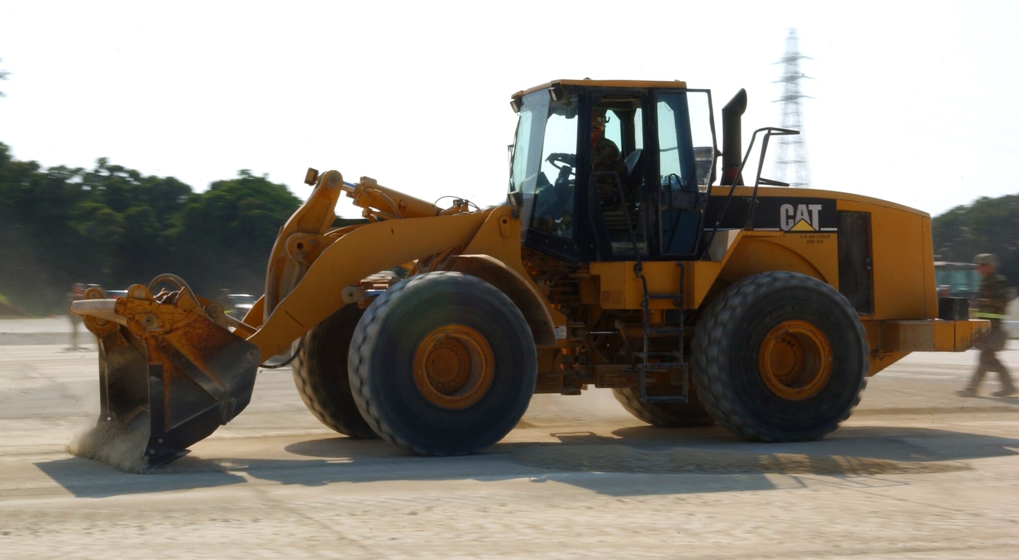 The 18th Civil Engineer Squadron and the Navy Seabees use heavy machinery to repair a simulated damaged runway at Kadena Air Base, Japan May 14, 2009. During the 18th Wing's weeklong local operational readiness exercise, the crews worked to patch 10-foot deep holes caused by mock bomb explosions. This was the first time both organizations practiced ADR in a simulated combat zone. The Seabees are in a 6 month rotation here and are being integrated into training with Airmen to capitalize on all engineering assets and fulfill the mission here.
(U.S. Air Force photo/Tech. Sgt. Rey Ramon) 
