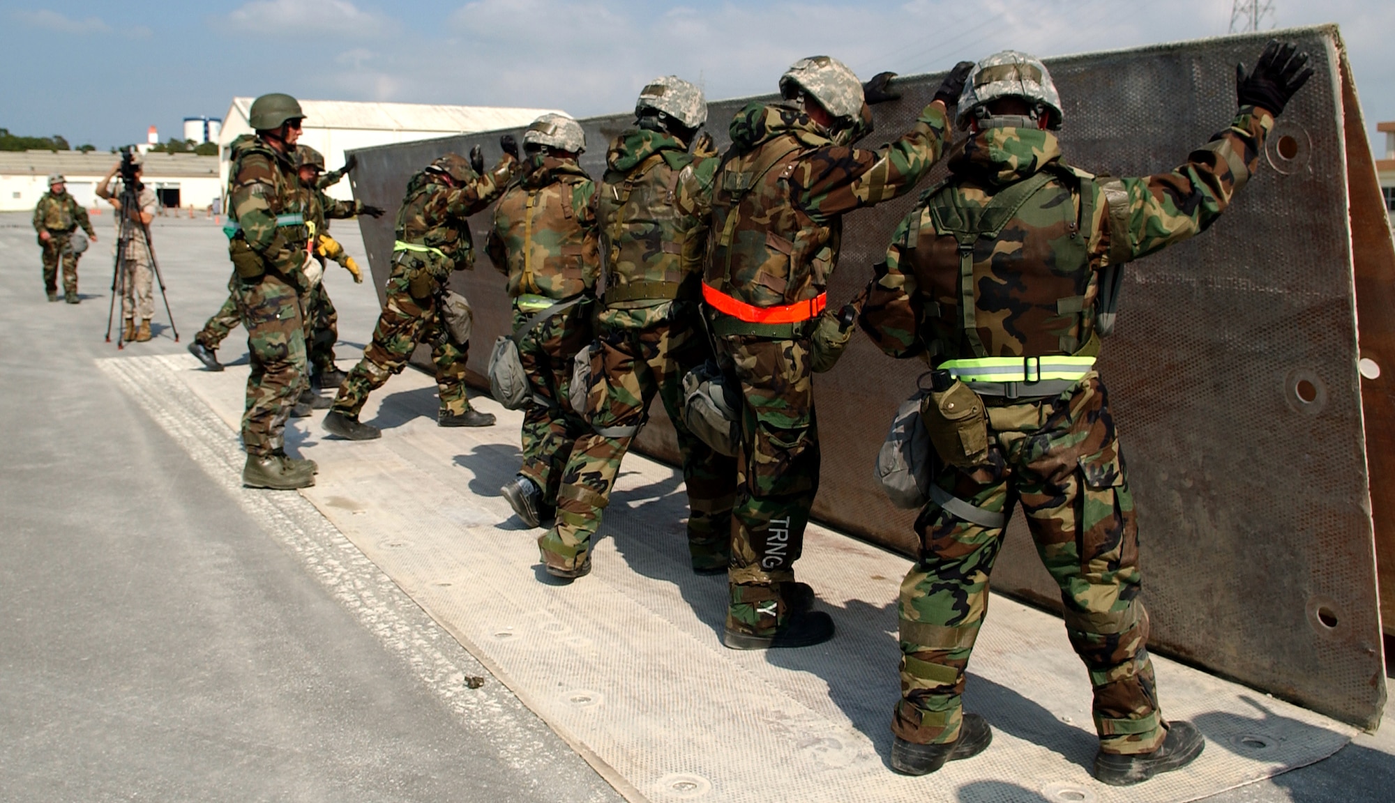 The 18th Civil Engineer Squadron and the Navy Seabees lay out a folded fiberglass mat which allows aircraft to land on a smooth surface at Kadena Air Base, Japan May 14, 2009. During the 18th Wing's weeklong local operational readiness exercise, the crews worked to patch 10-foot deep holes caused by mock bomb explosions. This was the first time both organizations practiced airfield damage repair in a simulated combat zone. The Seabees are in a 6 month rotation here and are being integrated into training with Airmen to capitalize on all engineering assets and fulfill the mission here.
(U.S. Air Force photo/Tech. Sgt. Rey Ramon) 