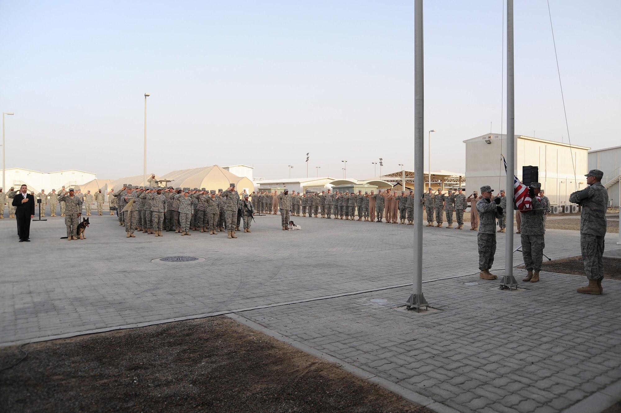 SOUTHWEST ASIA - Maj. Christopher Bromen, 380th Expeditionary Security Forces Squadron, commander, leads 380th ESFS and Office of Special Investigation personnel in saluting the colors as the flag is retired during a retreat ceremony, May 15 at an undisclosed location in Southwest Asia. Names of fallen ESFS and OSI members were read followed by a moment of silence with the retreat ceremony concluding the event that was performed as part of National Police Week to honor the service and sacrifice of U.S. law enforcement officials. (U.S. Air Force photo by Senior Airman Brian J. Ellis) (Released)