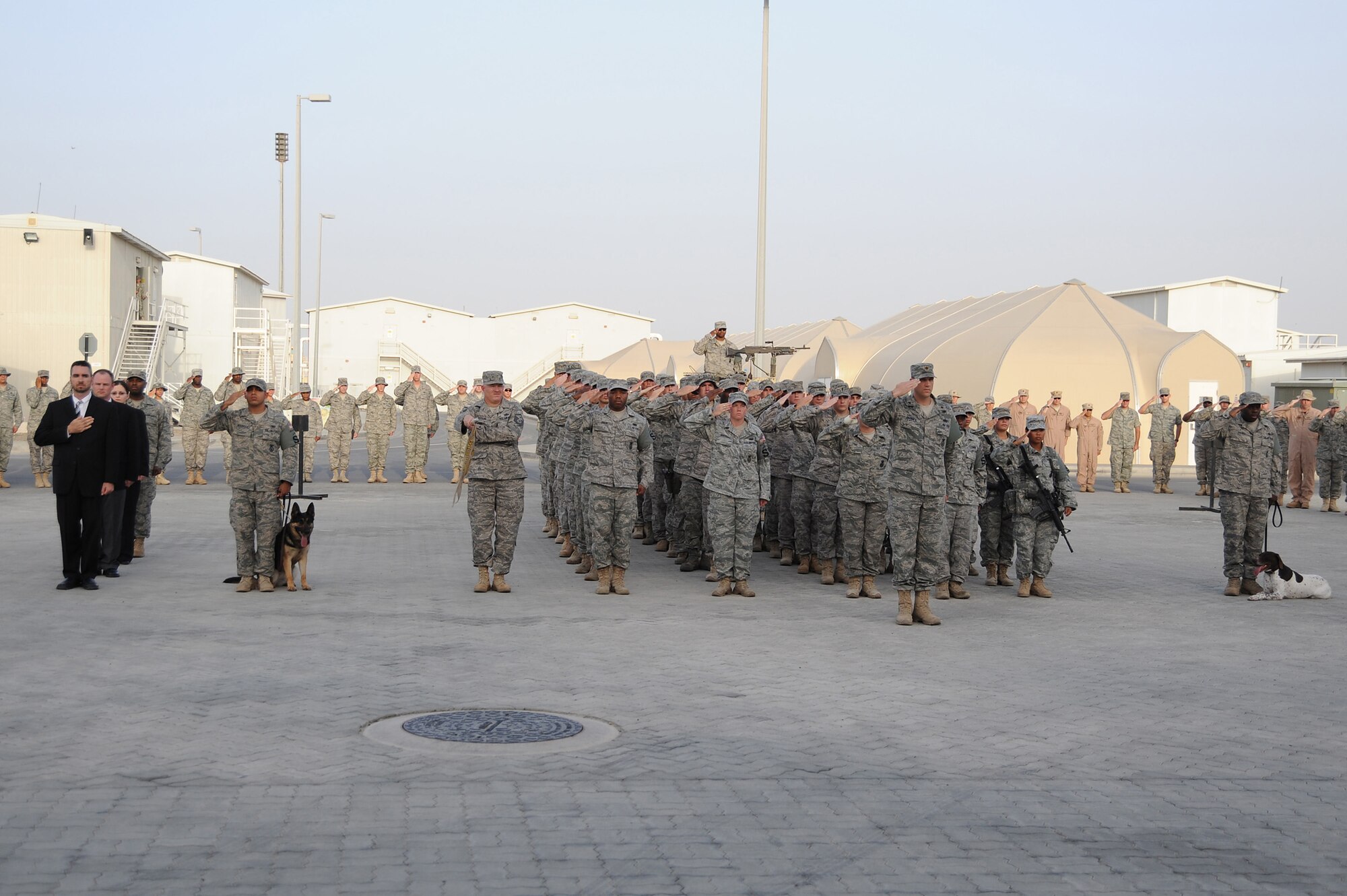 SOUTHWEST ASIA - Maj. Christopher Bromen, 380th Expeditionary Security Forces Squadron, commander, leads 380th ESFS and Office of Special Investigation personnel in saluting the colors as the flag is retired during a retreat ceremony, May 15 at an undisclosed location in Southwest Asia. Names of fallen ESFS and OSI members were read followed by a moment of silence with the retreat ceremony concluding the event that was performed as part of National Police Week to honor the service and sacrifice of U.S. law enforcement officials. (U.S. Air Force photo by Senior Airman Brian J. Ellis) (Released)