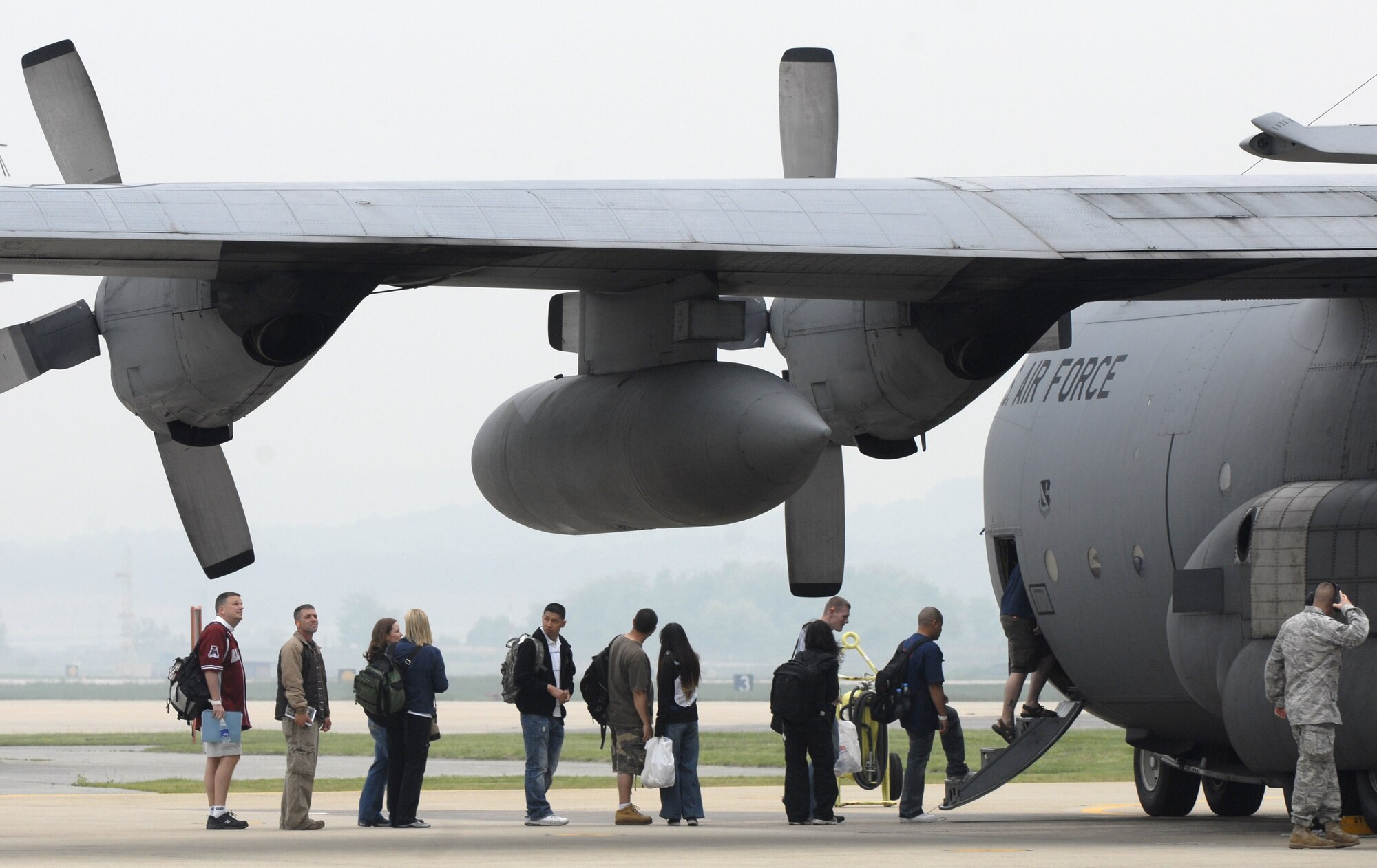 OSAN AIR BASE, Republic of Korea -- Passengers board a flight to Yokota Air Base, Japan May 15 during a semi-annual noncombatant evacuation operations exercise, Courageous Channel. The exercise tested the command’s NEO plans and procedures for a short-notice evacuation of non-combatants.  (U.S. Air Force photo/Staff Sgt Brian Ferguson)