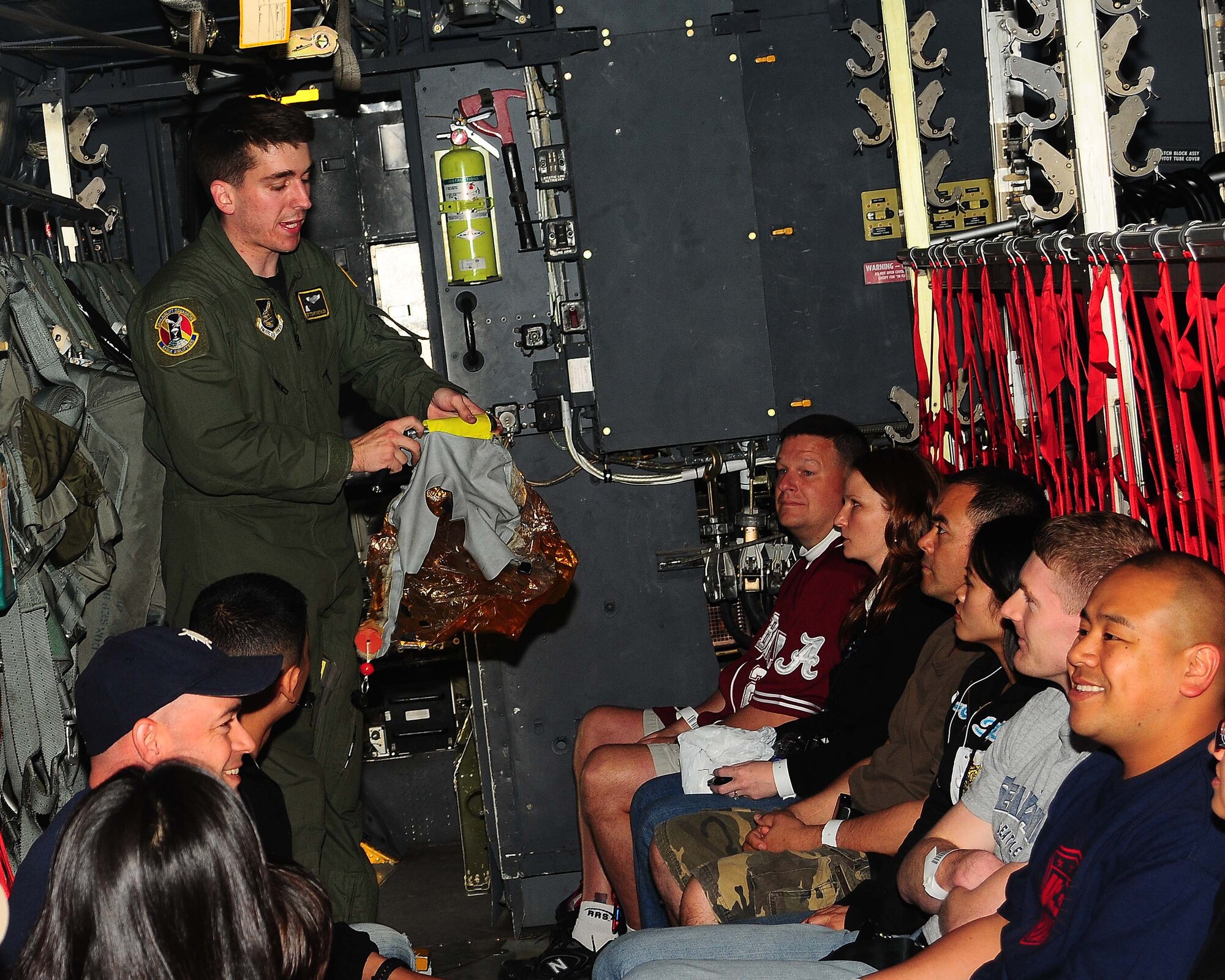 YOKOTA AIR BASE, Japan -- Staff Sgt Stewart Guethlein, 36th Airlift Wing loadmaster, briefs passengers on how to properly don an oxygen mask May 15 during a semi-annual noncombatant evacuation operations exercise, Courageous Channel.  Yokota's C-130 aircrew flew to Osan Air Base, Republic of Korea, picked up 50 noncombatants and returned to Yokota Air Base. (U.S. Air Force photo/Airman Sean Martin)
