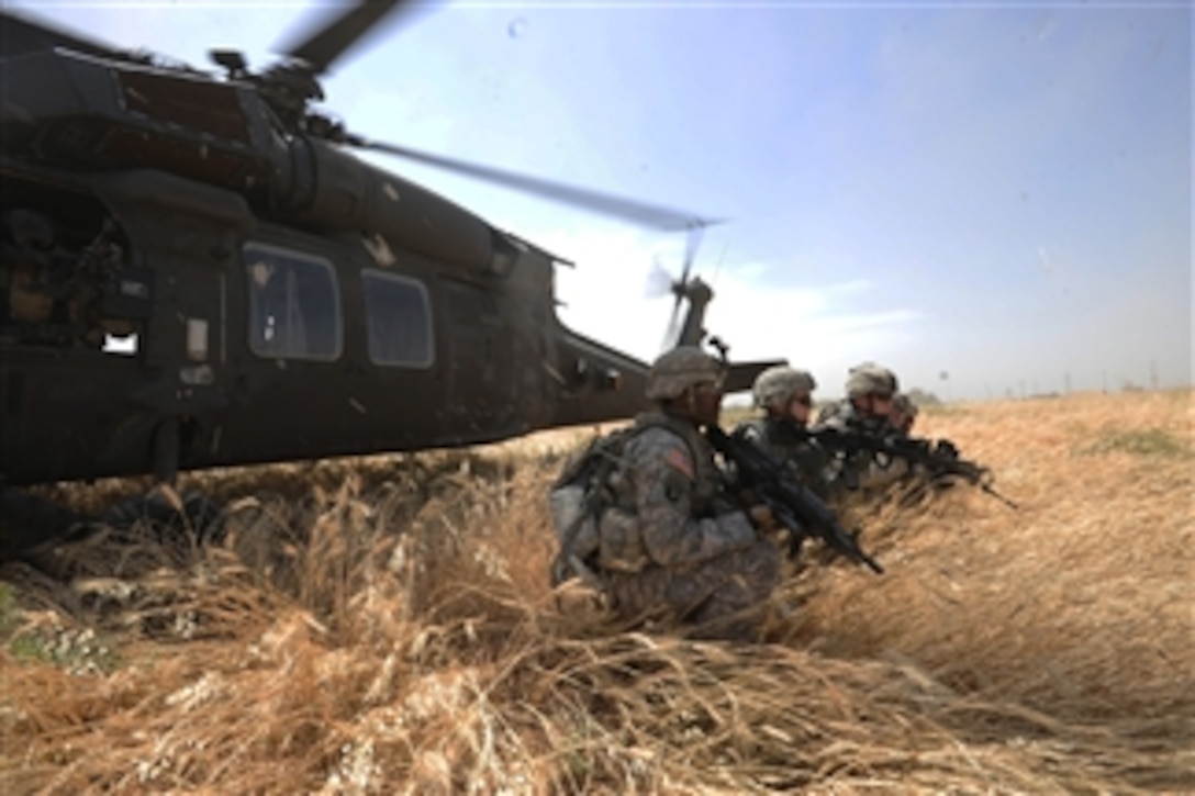 U.S. Army soldiers set up security after exiting a UH-60 Blackhawk helicopter during a Joint Air Assault Operation with the Iraqi army to establish a hasty traffic control point to intercept and prevent illegal weapons movement near Mushada, Iraq, on May 11, 2009.  The soldiers are assigned to 4th Platoon, Alpha Company, 1st Battalion, 111th Infantry Regiment, 56th Stryker Brigade Combat Team, 28th Infantry Division, Pennsylvania National Guard Multi-National Division Baghdad.  