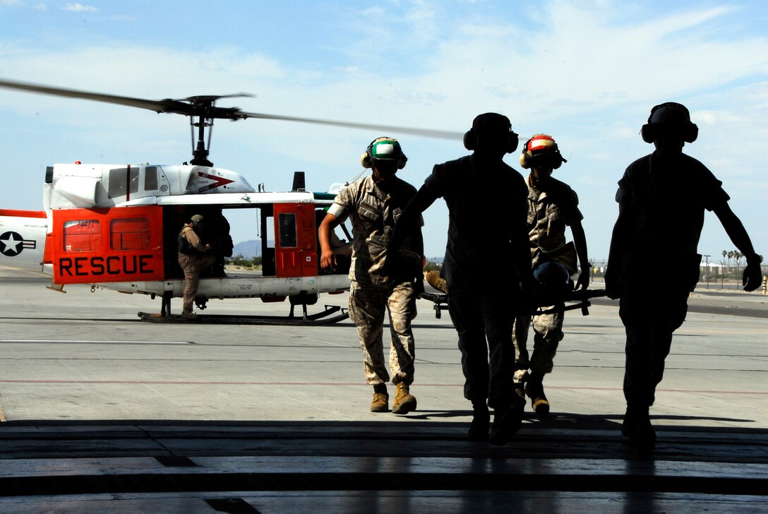 Students in a recent Corporal’s Course carry a simulated victim from a UH-1N Search and Rescue helicopter into the SAR hangar May 19, 2009, on the Marine Corps Air Station in Yuma, Ariz. After receiving a class from Petty Officer 1st Class Jason Conley, a station SAR corpsman, the 34 Marines in the course practiced loading and unloading simulated victims on and off a helicopter. This is the first time the course has done this training, and instructors are considering making it a permanent part of the curriculum. The course graduated May 22, 2009.
