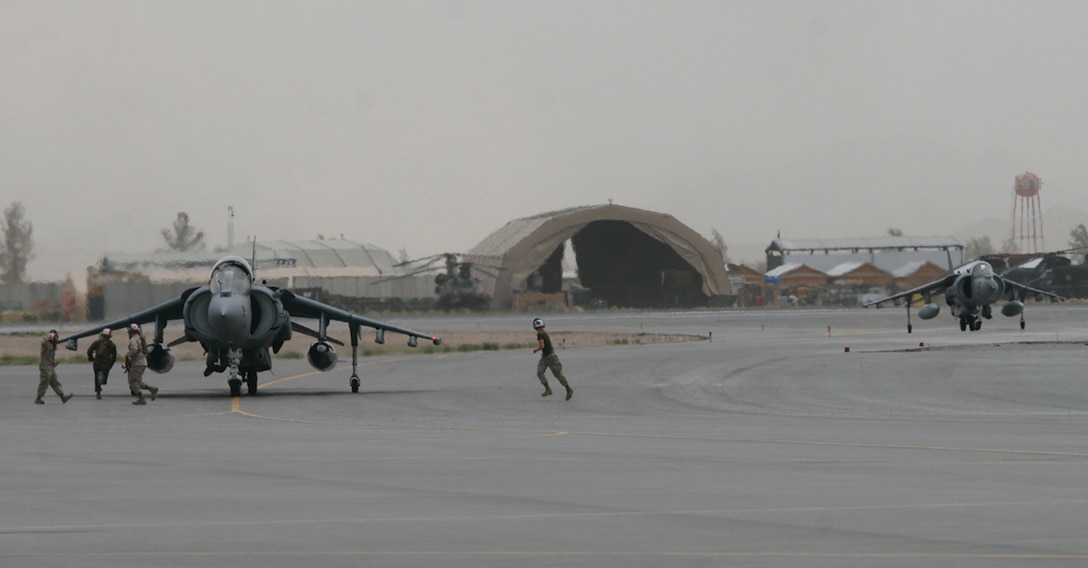 A pair of AV-8B Harriers from Yuma’s Marine Attack Squadron 214 taxi during a dust storm at Kandahar Air Base in Afghanistan, May 19, 2009. VMA-214 deployed 10 Harriers and nearly 200 personnel to Afghanistan in early May. The unit is currently preparing for the summer’s combat operations. (Photo by Lance Cpl. Gregory Aalto)