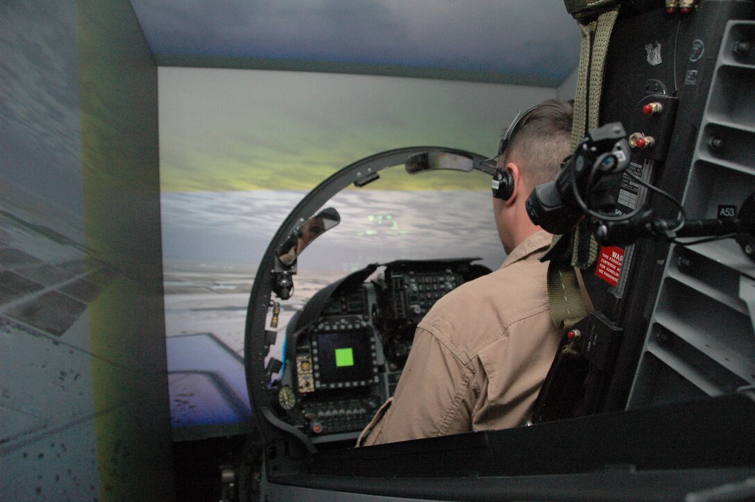 Maj. Grant Pennington, Marine Corps Air Station Yuma, Ariz., Marine Aviation Training Systems Site officer in charge, performs tests run of the new AV-8B Harrier simulator May 19, 2009. The simulator, which can run both day and night missions, is scheduled to be available to pilots Aug. 31, 2009. MATSS plans to receive two F-35 Joint Strike Fighter simulators and possibly one unmanned aerial vehicles simulator within a year or two, and have them linked on a local network with its two Harrier simulators. MATSS also plans for the simulators to eventually be linked to a joint, nationwide network by 2012, allowing pilots here to fly simulated scenarios with other services and their respective aircraft.(Photo by Lance Cpl. Austin Hazard)